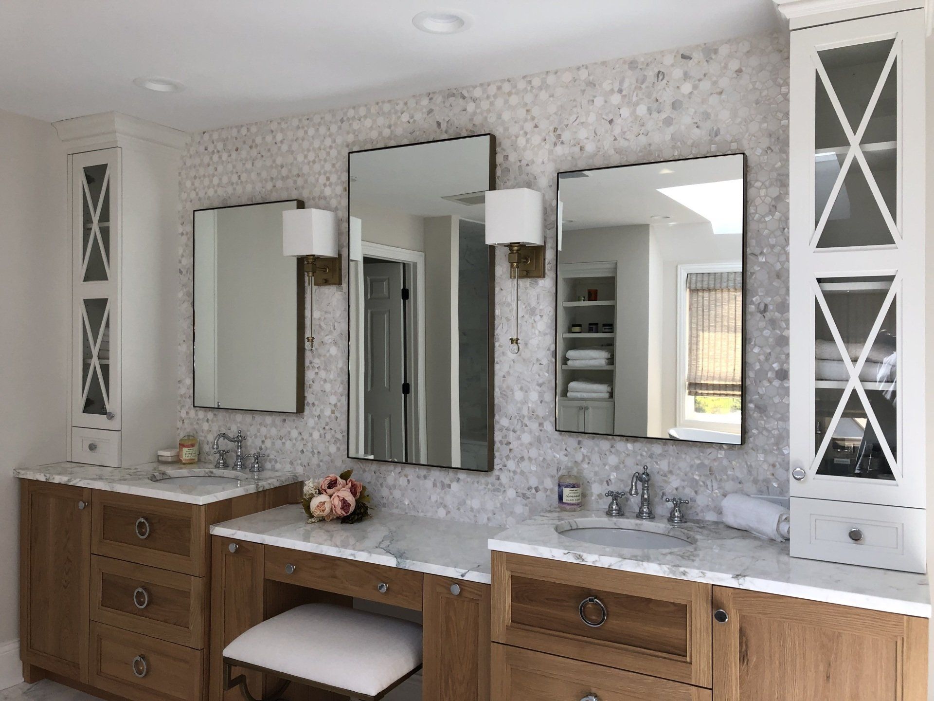 A bathroom with two sinks and two mirrors.