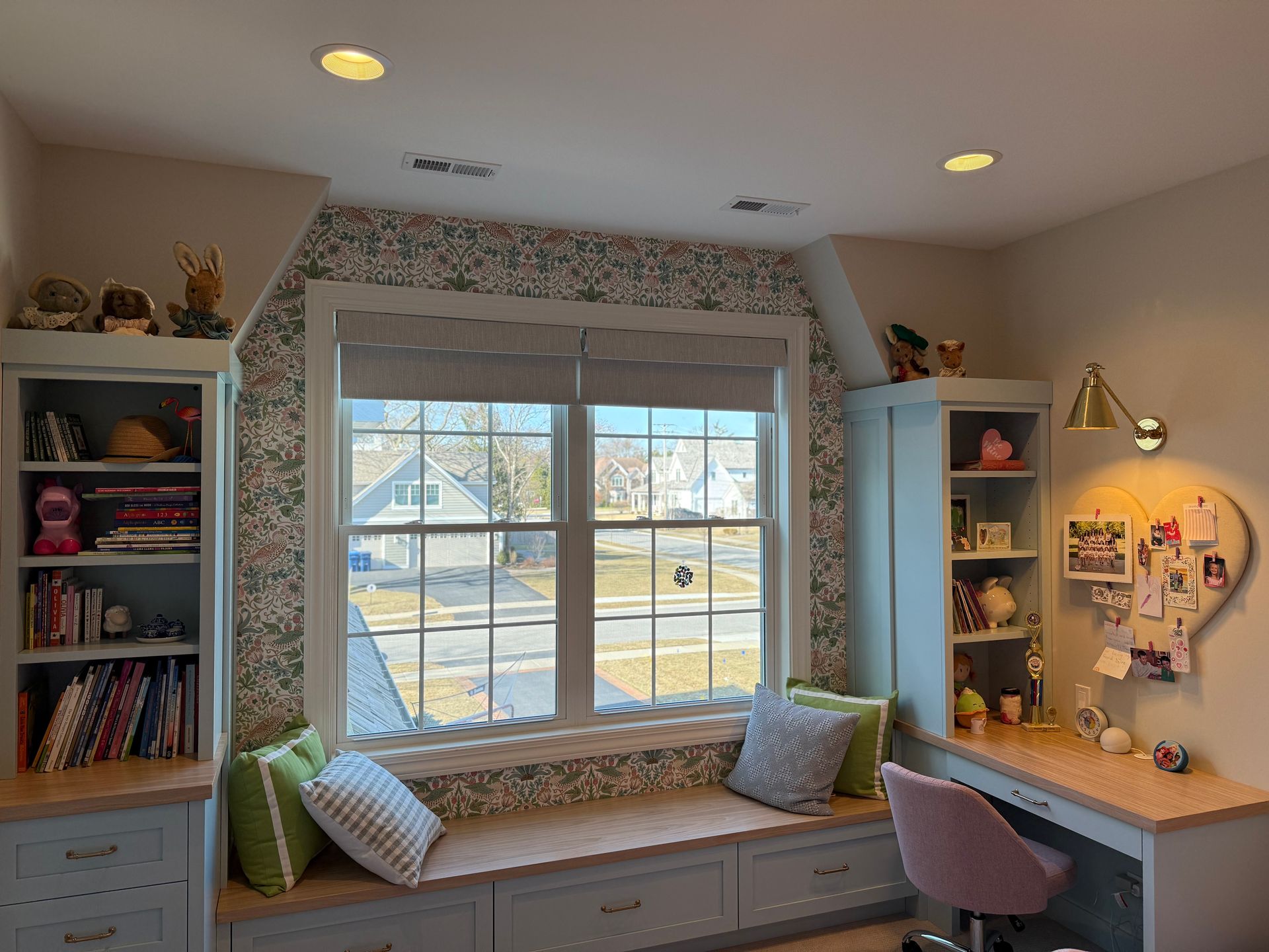 A room with a window seat and a desk