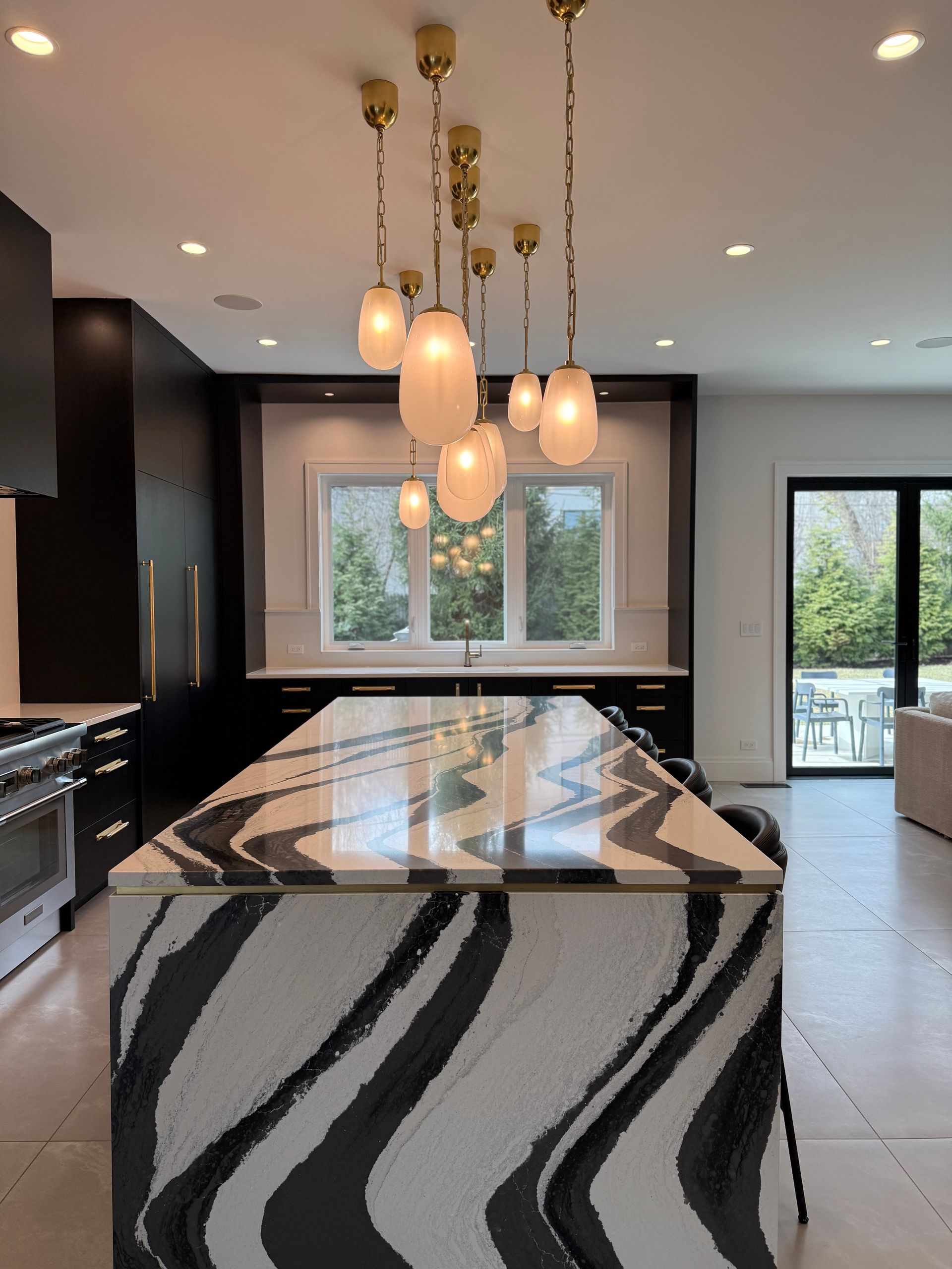 A kitchen with a large island with a zebra print counter top