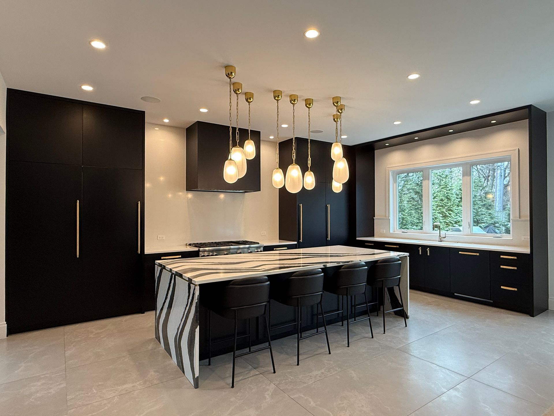 A large kitchen with a large island and stools.
