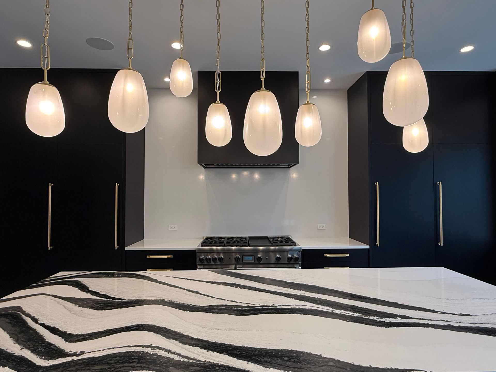 A kitchen with black cabinets and a white counter top