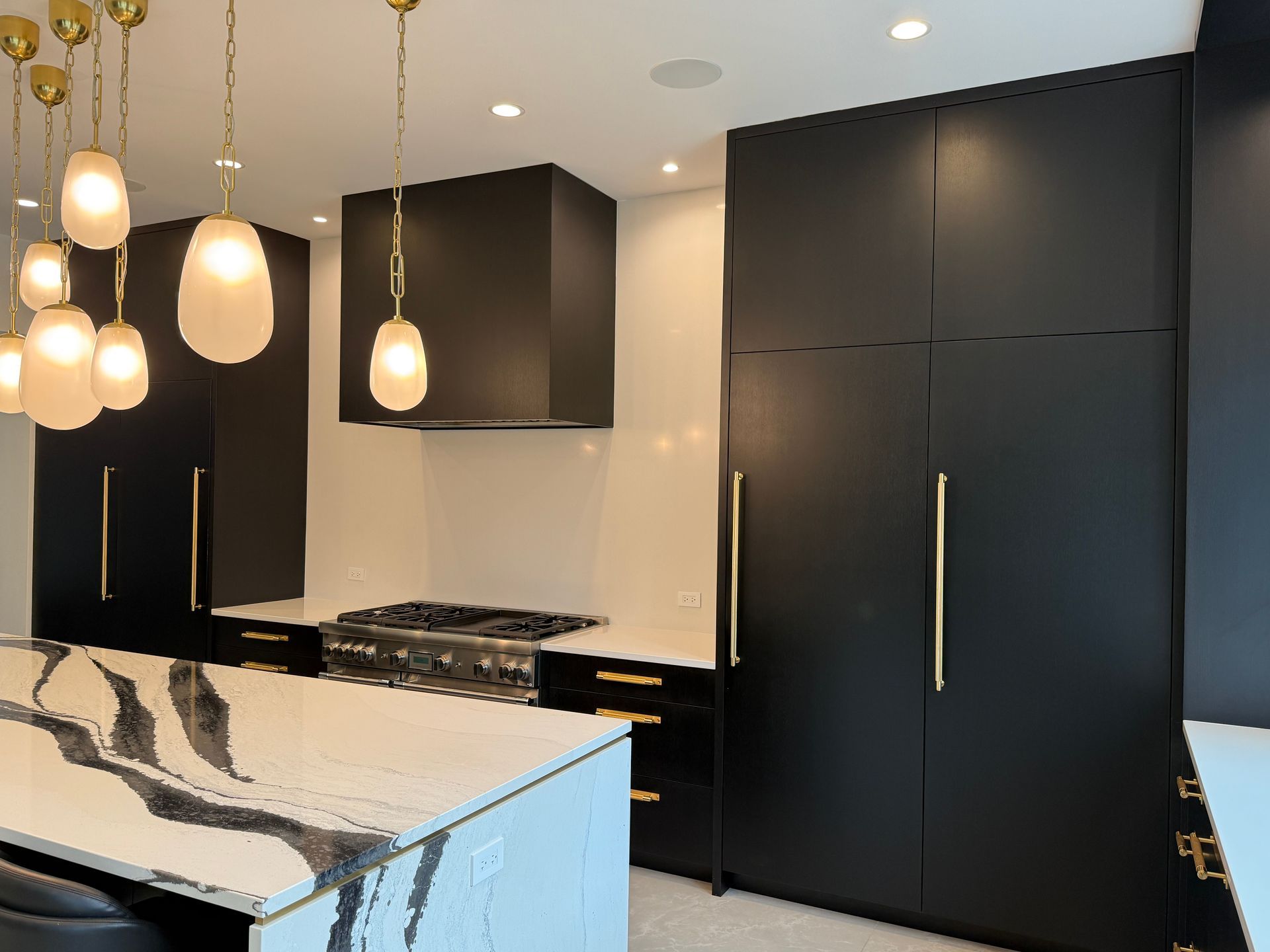 A kitchen with black cabinets and a white counter top.