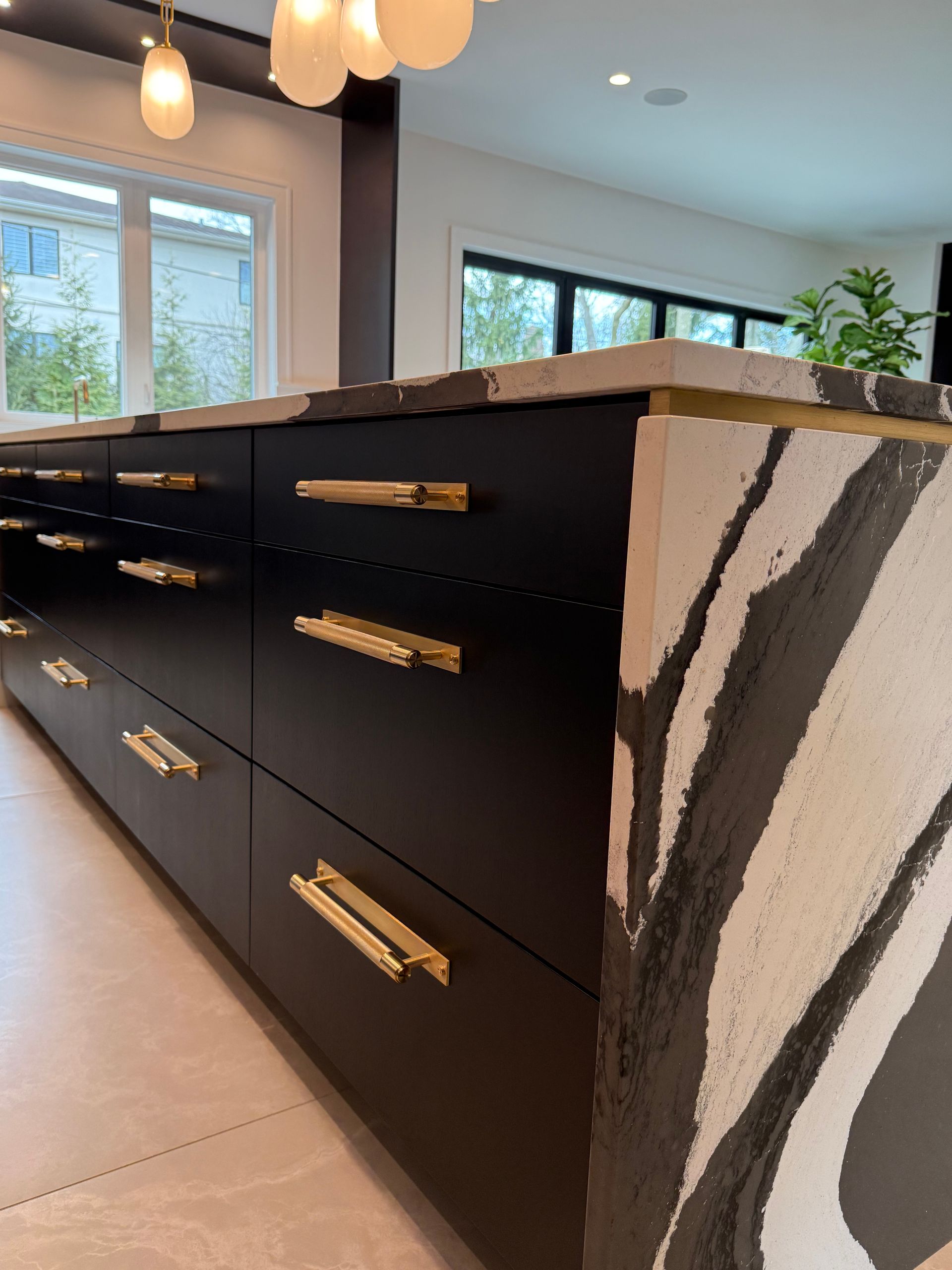 A kitchen with black cabinets and a zebra print counter top