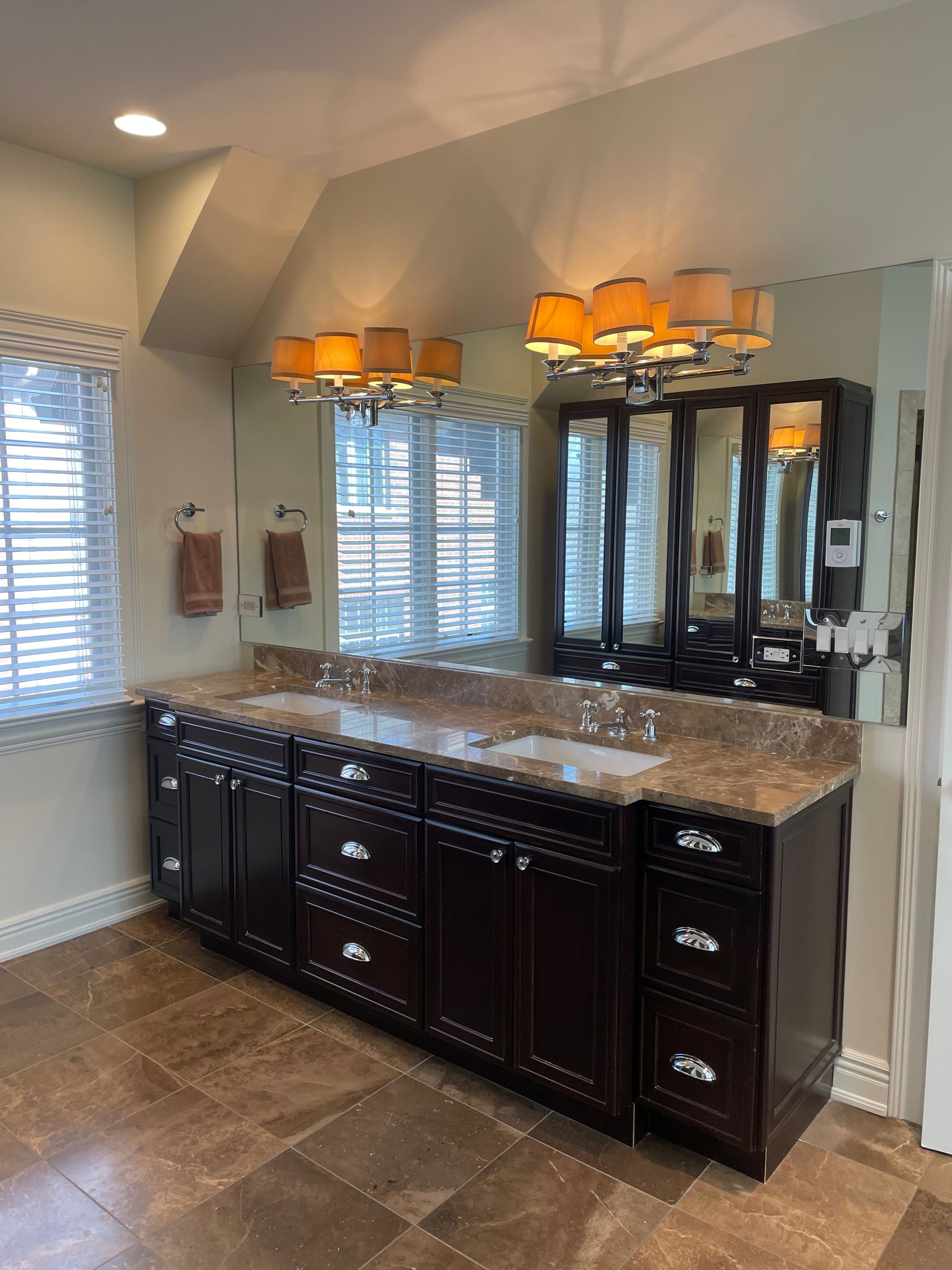 A bathroom with two sinks and a large mirror.