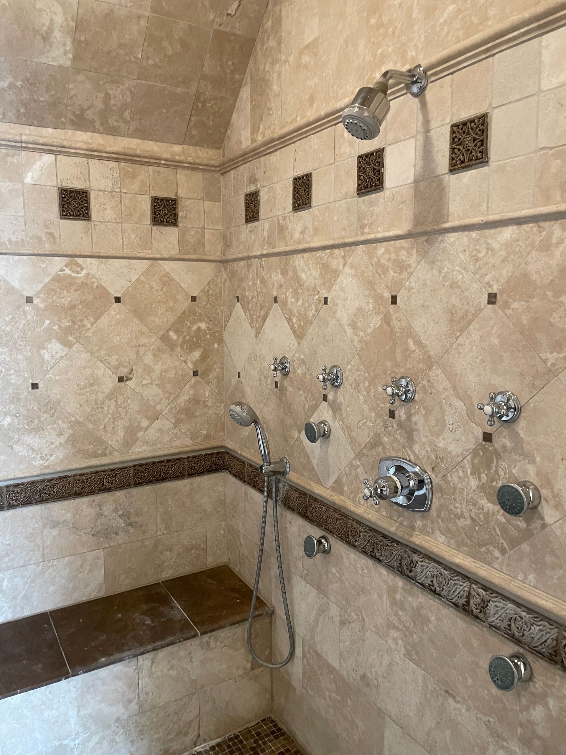 A bathroom with a shower and a bench.