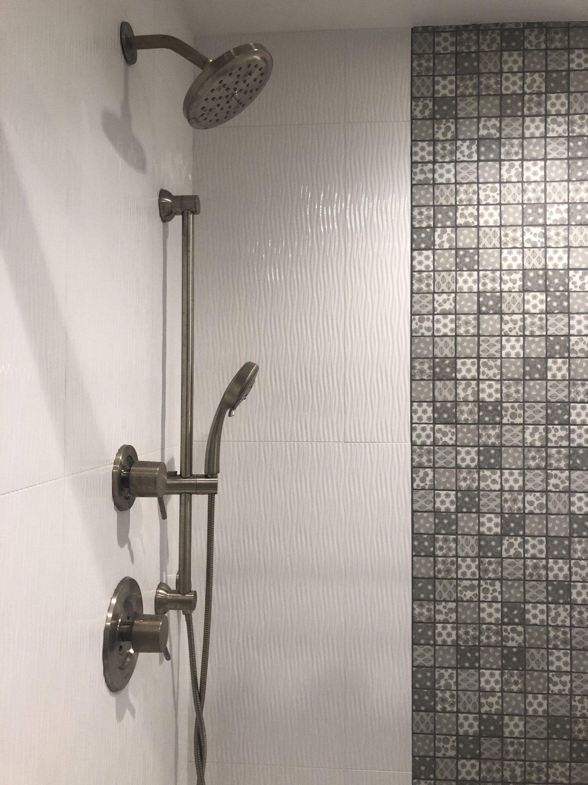 A black and white photo of a shower with a shower head.