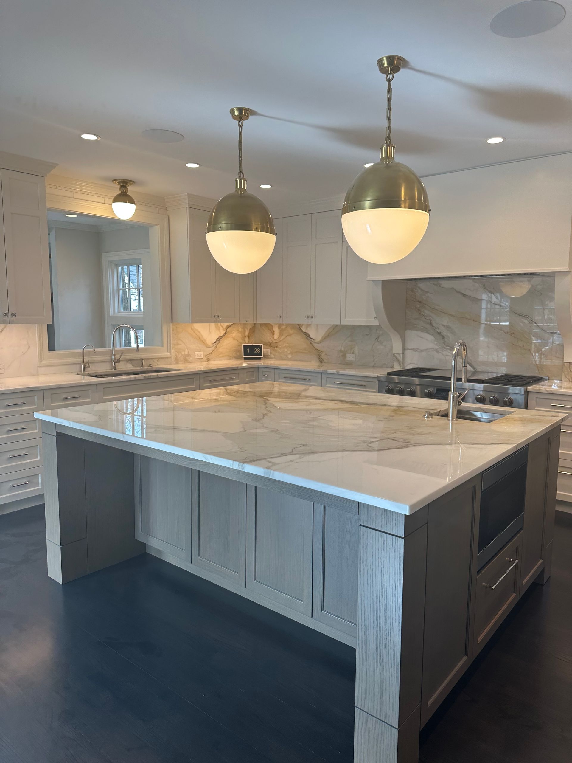 There is a large island in the middle of the kitchen.