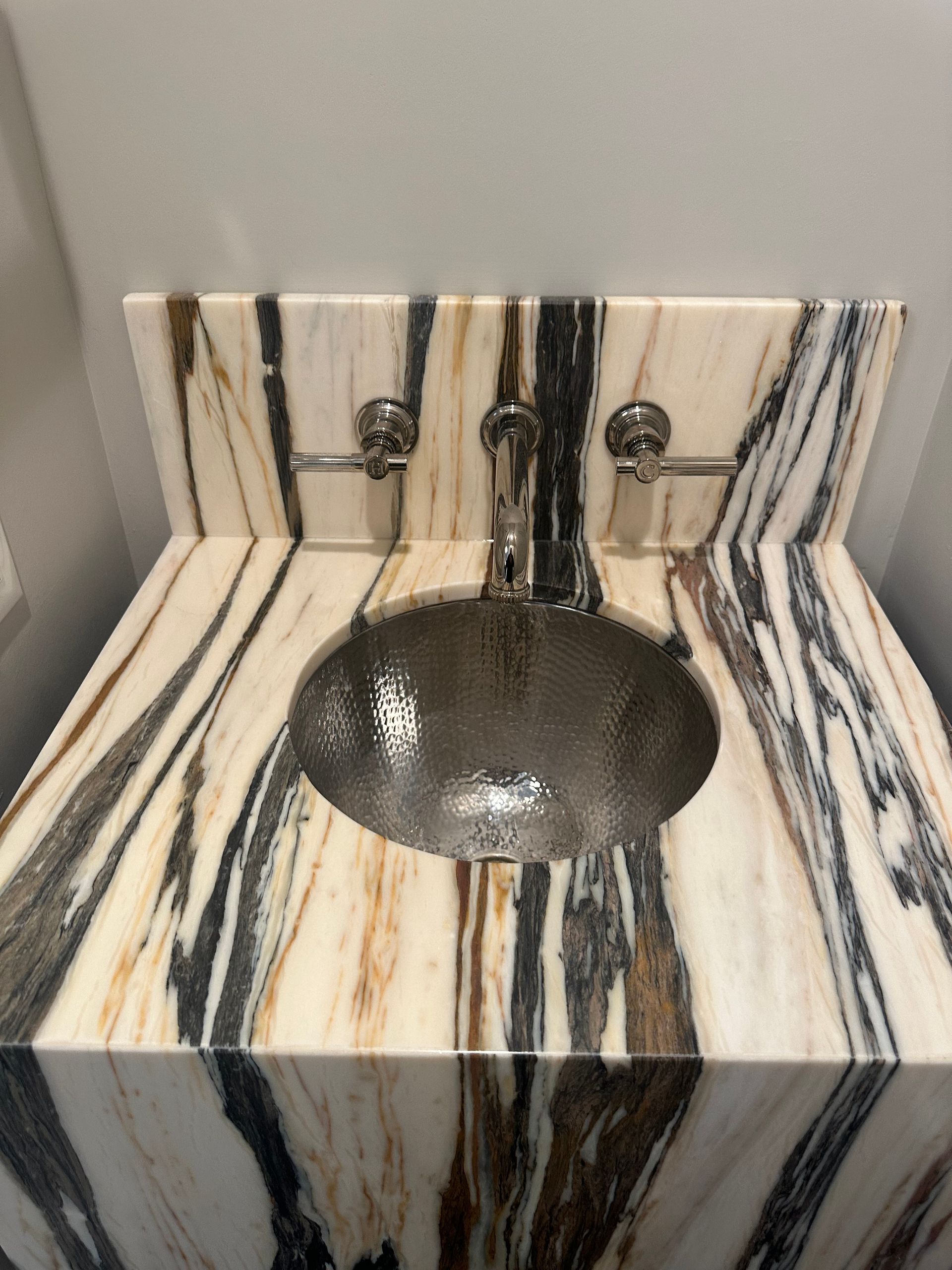 A bathroom sink with a zebra print counter top