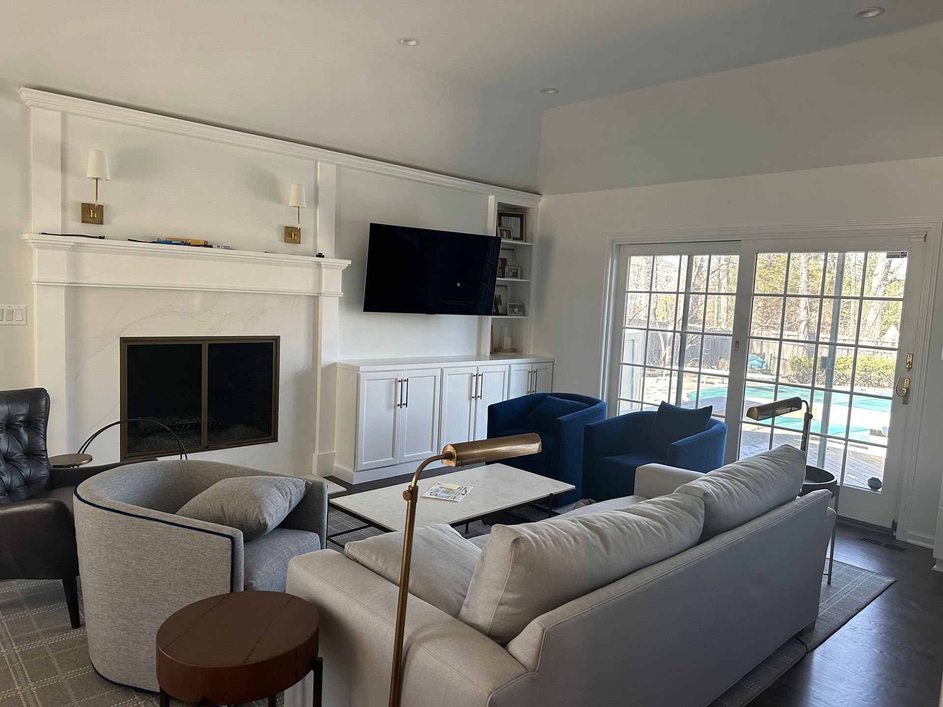 A living room with a couch , chairs and a fireplace