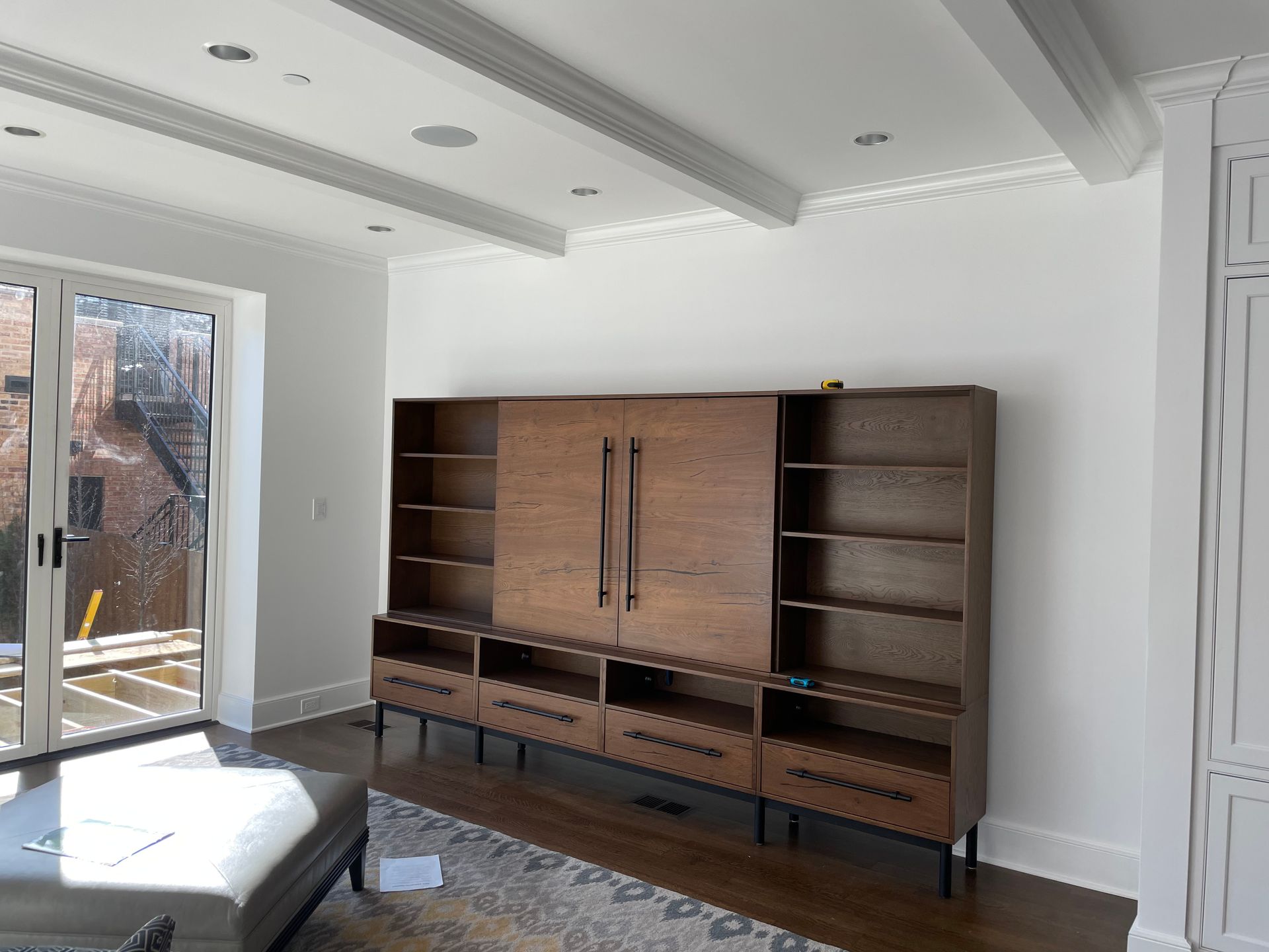 A living room with a lot of shelves and drawers