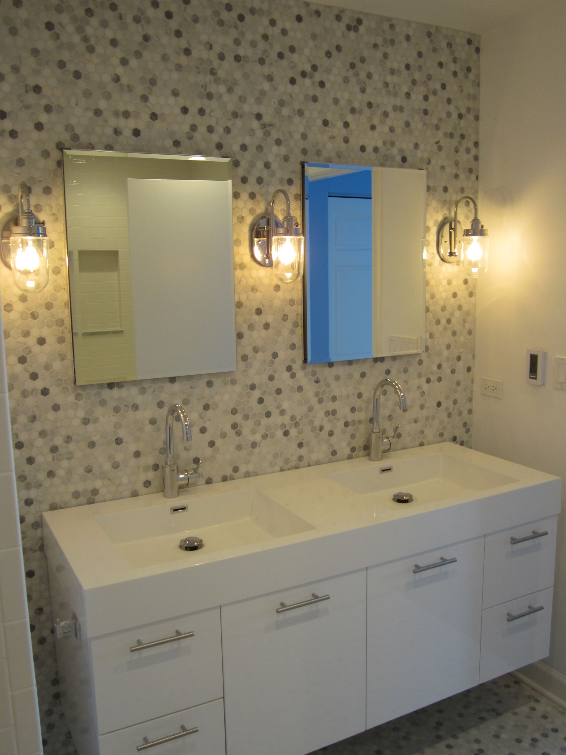 A bathroom with two sinks and a mirror