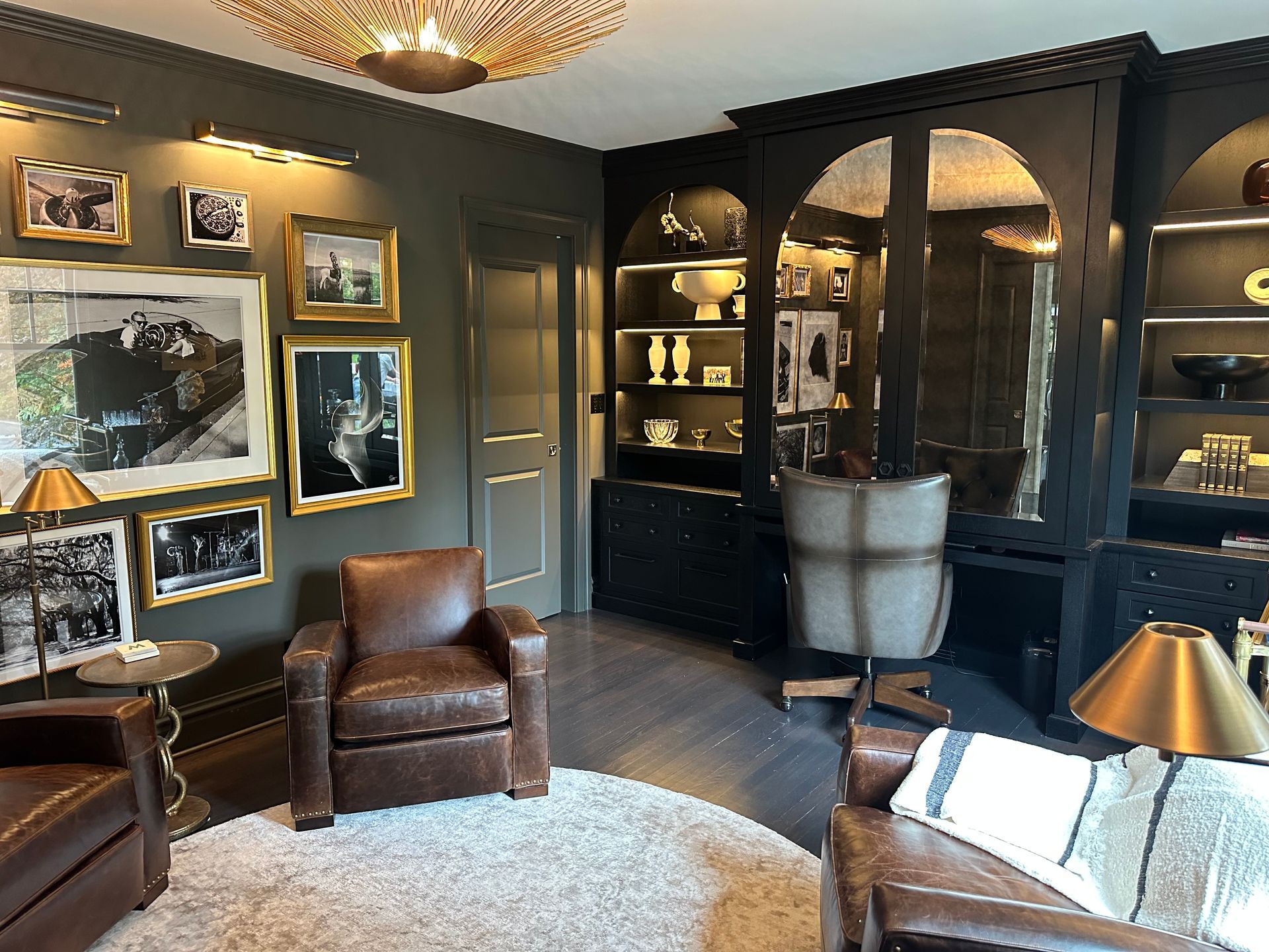 A living room filled with furniture and pictures on the wall.