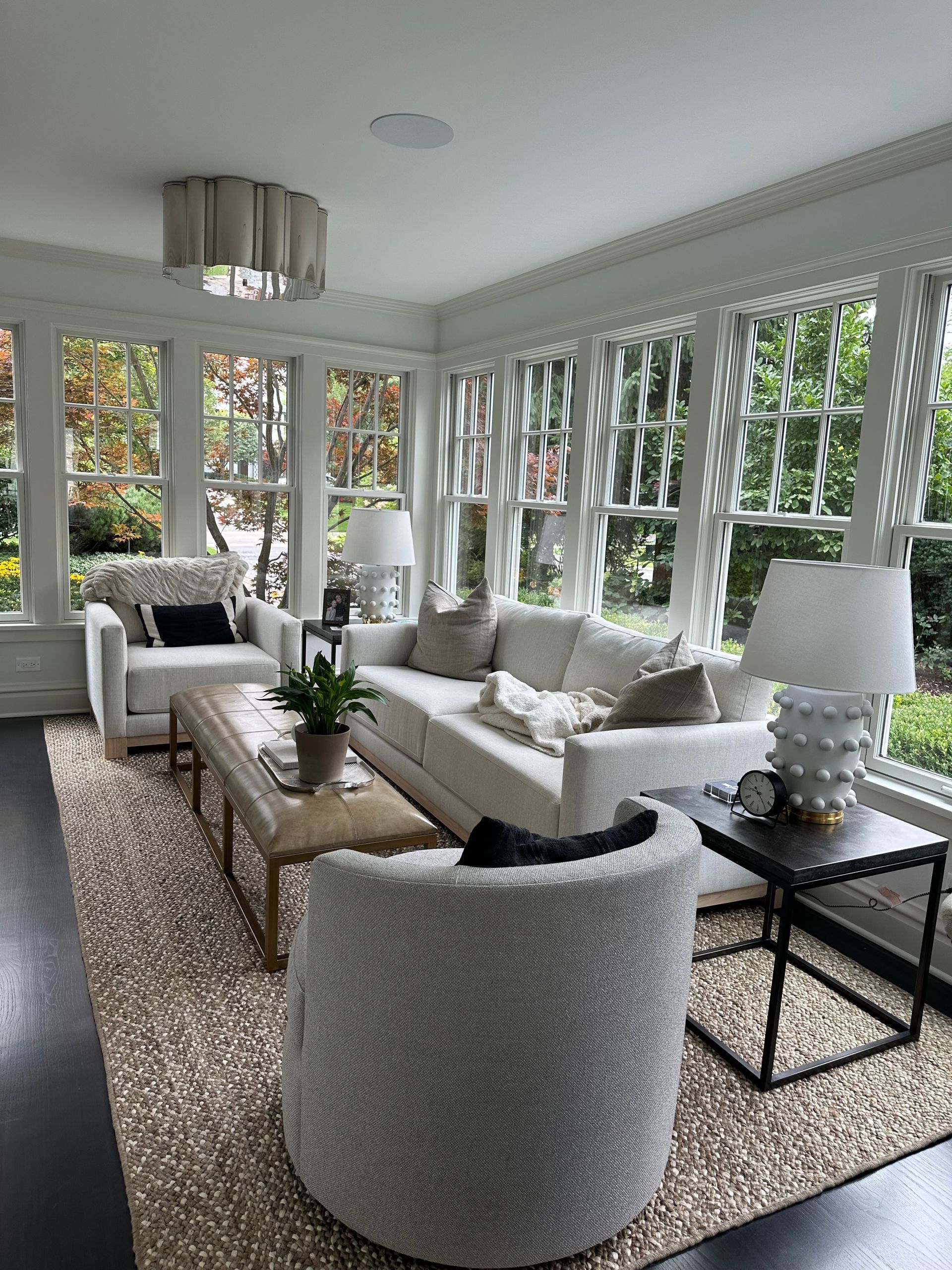 A living room filled with furniture and lots of windows.