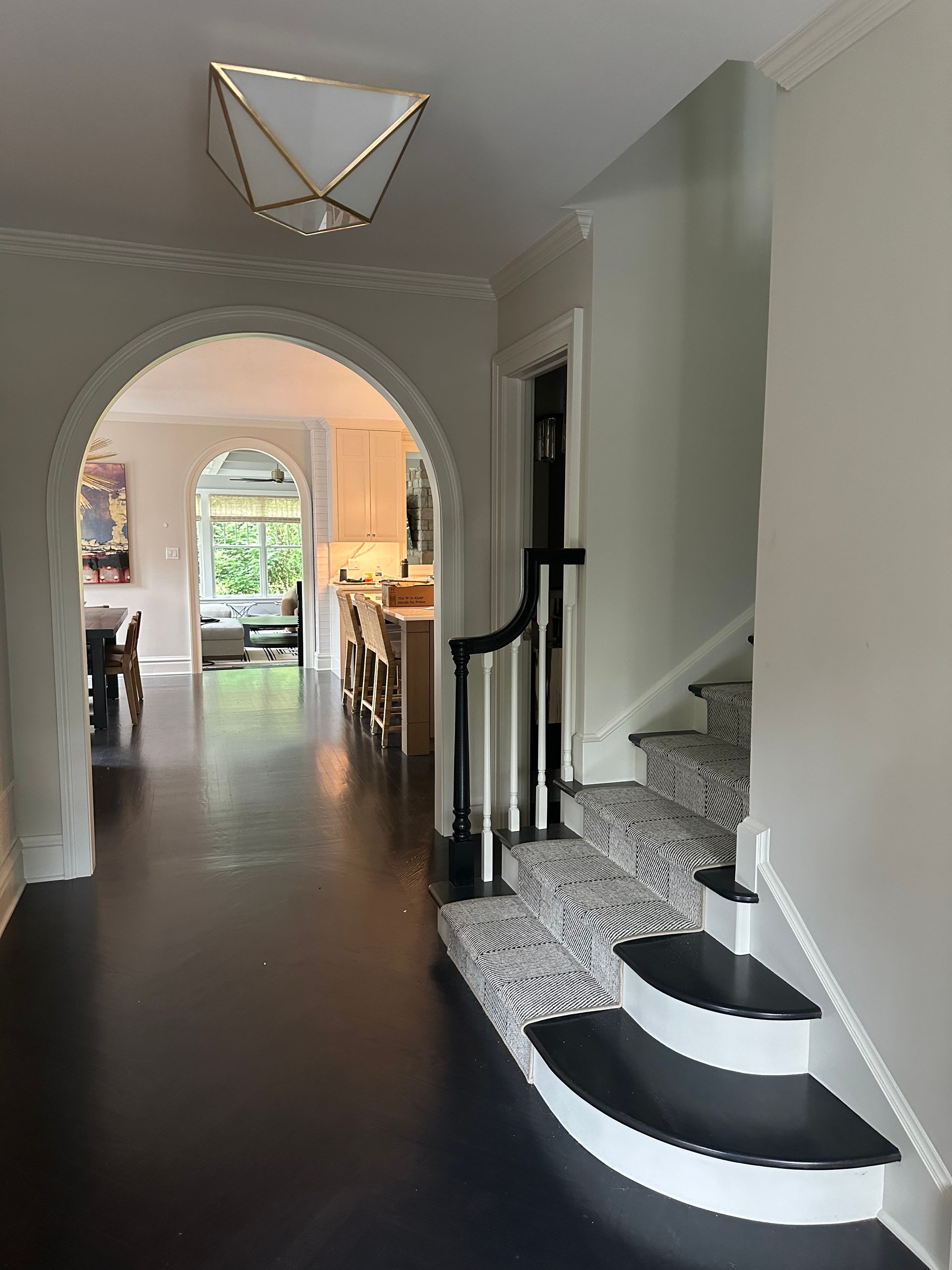 A hallway with stairs leading up to the second floor of a house.