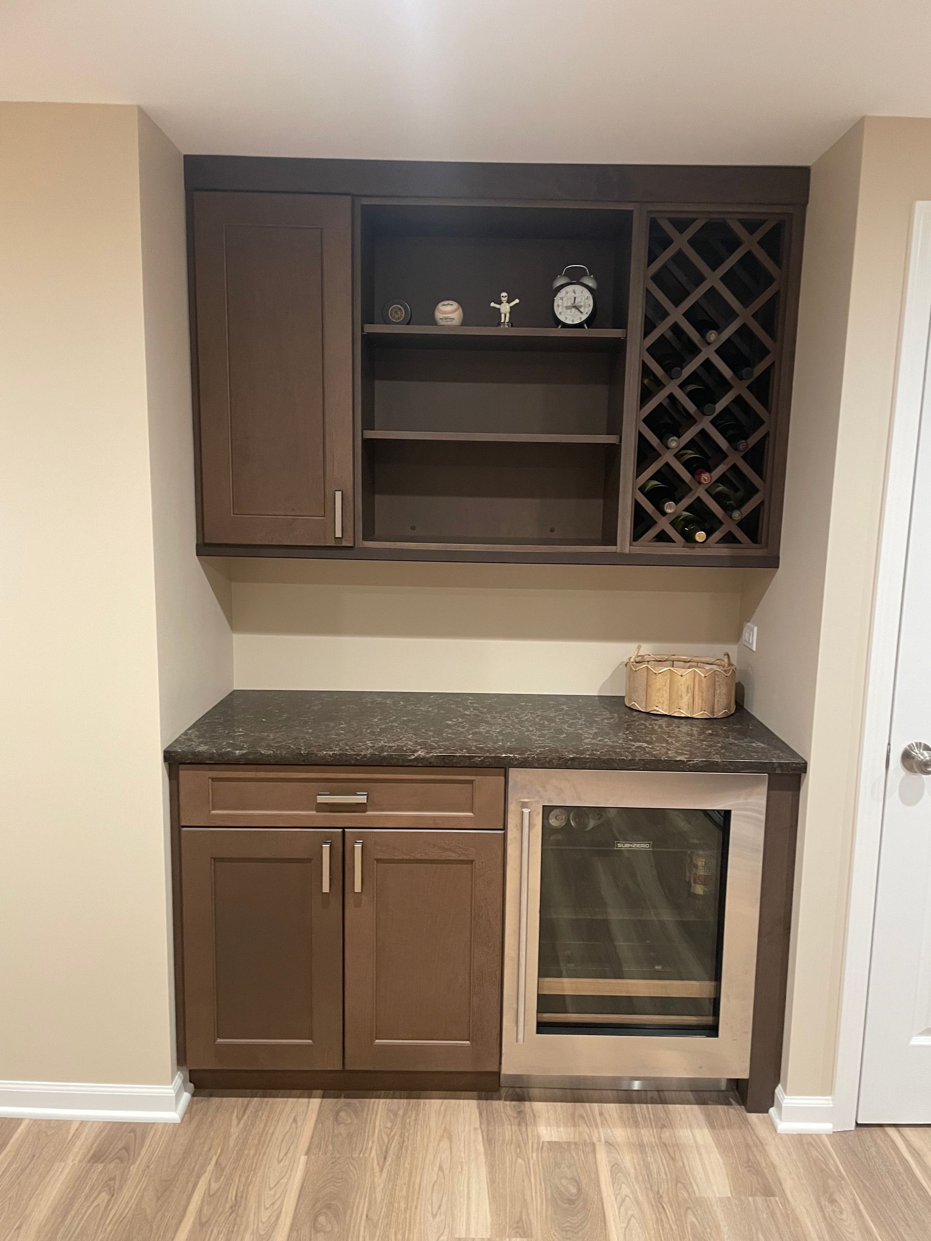 A kitchen with a wine rack and a refrigerator.