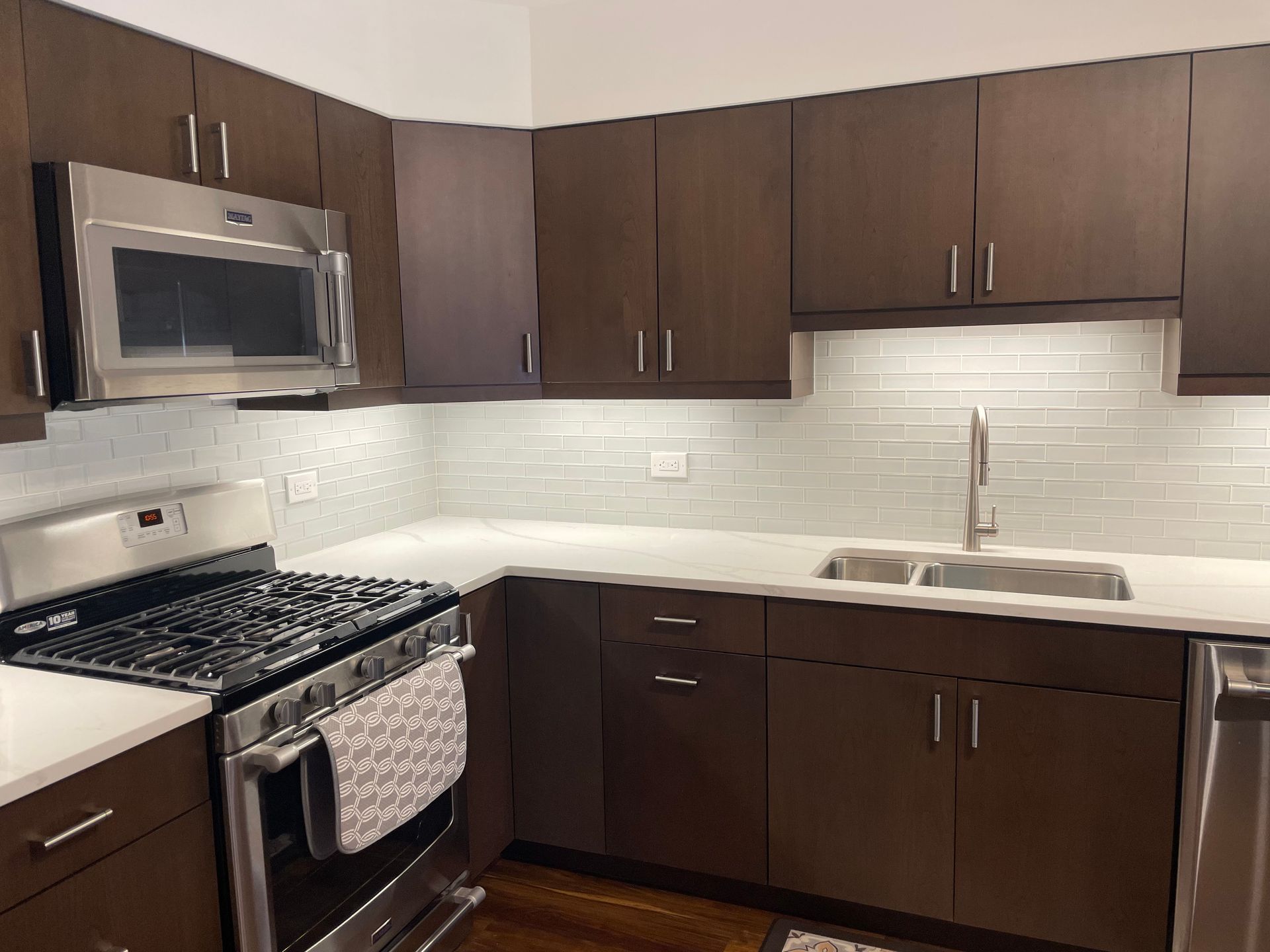 A kitchen with stainless steel appliances and wooden cabinets
