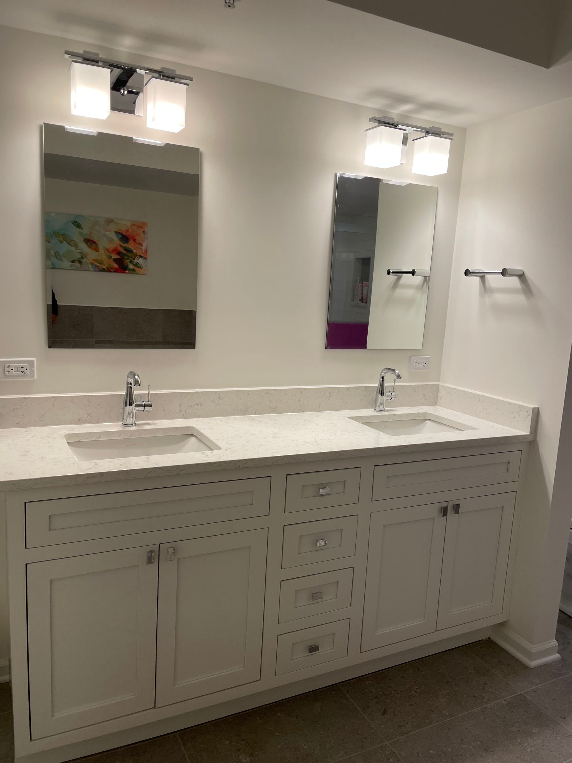 A bathroom with two sinks and two mirrors