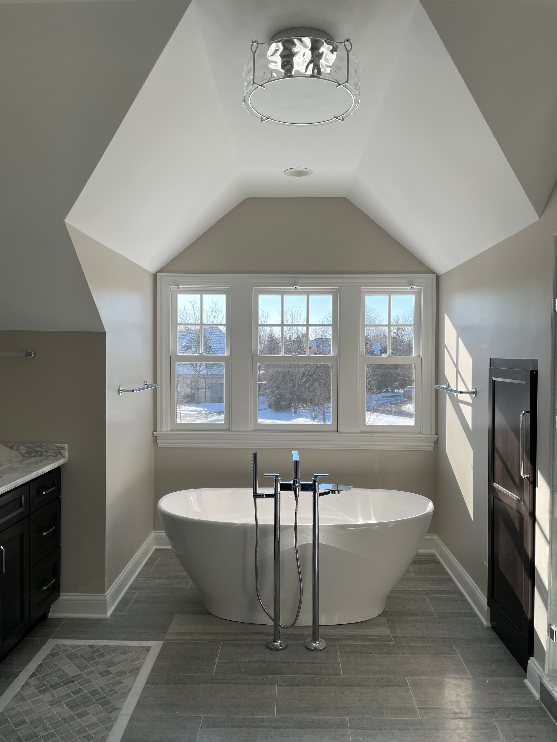 A bathroom with a bathtub and a window