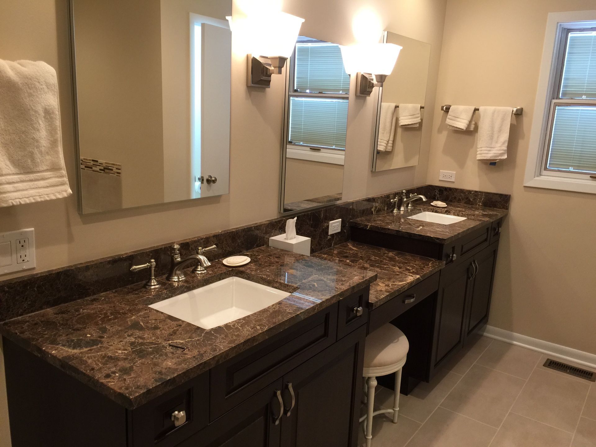 A bathroom with two sinks and two mirrors.
