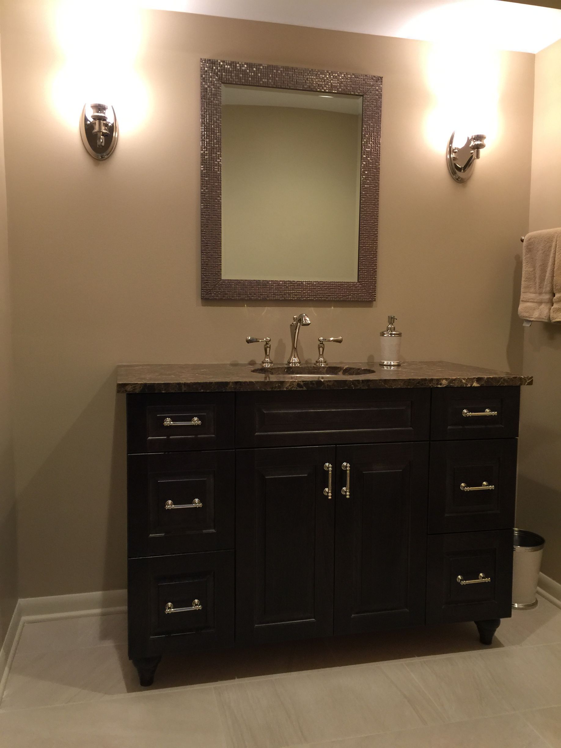 A bathroom with a sink and a mirror on the wall