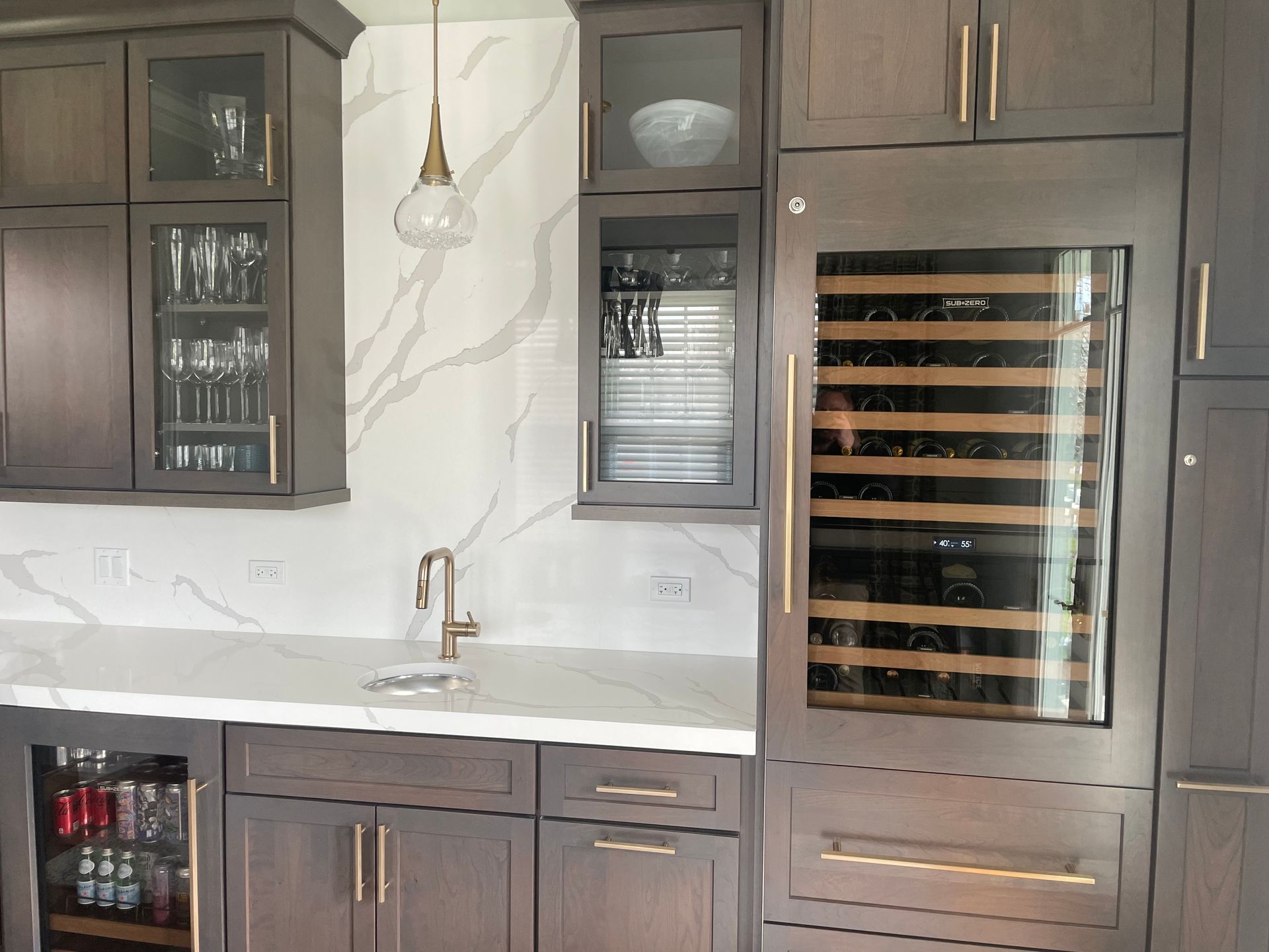 A kitchen with a wine cooler and a sink