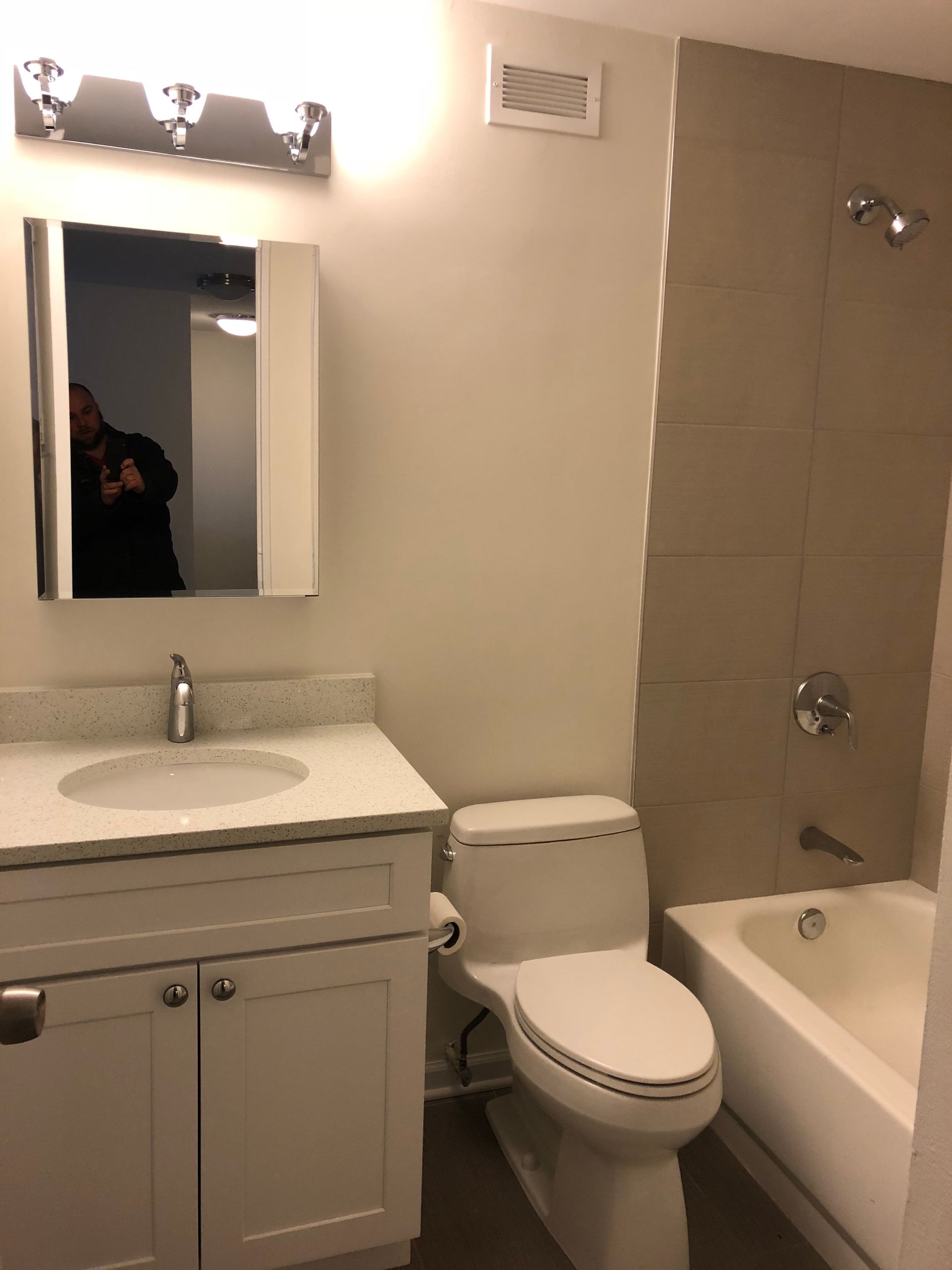 A bathroom with a toilet a sink and a bathtub