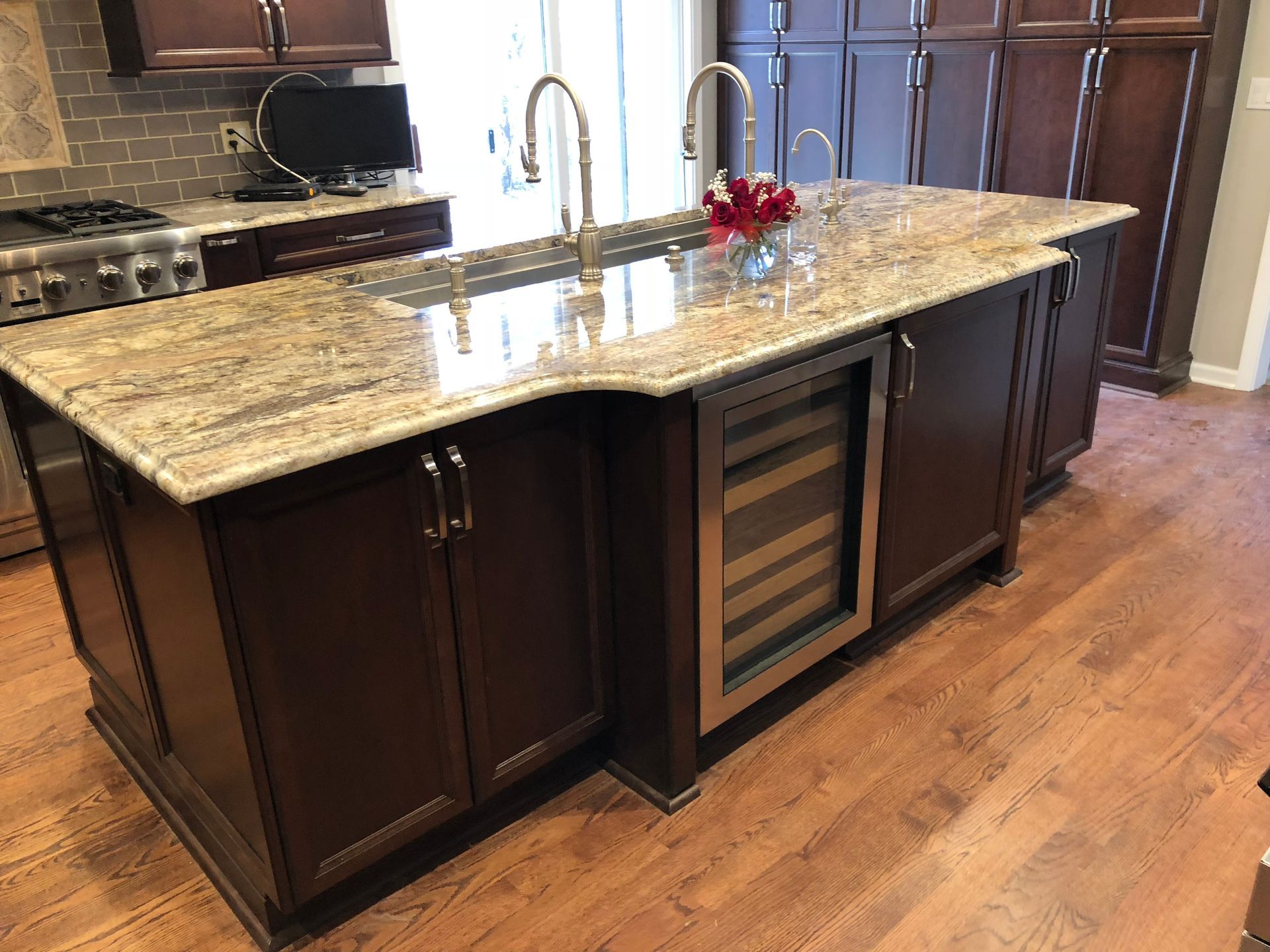 A kitchen with a large island and granite counter tops.