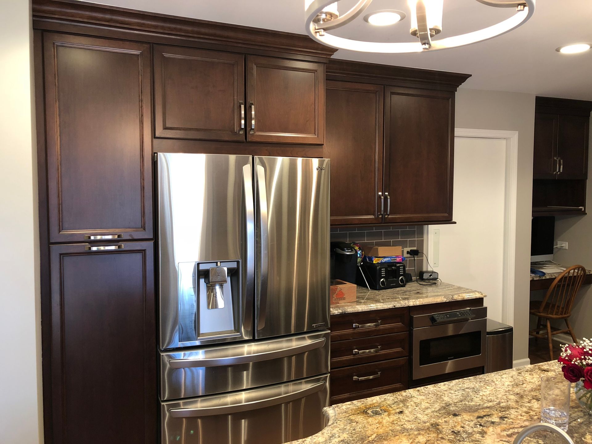 A kitchen with stainless steel appliances and wooden cabinets