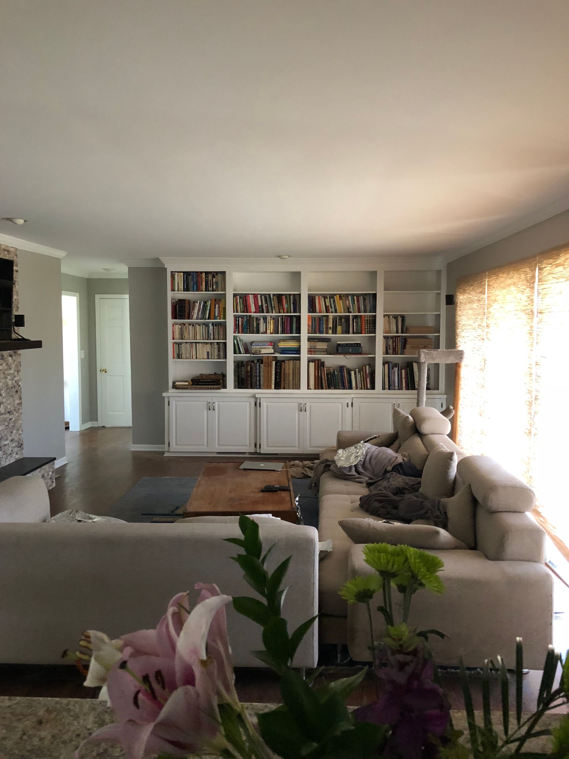 A living room with a couch , bookshelf , and fireplace.