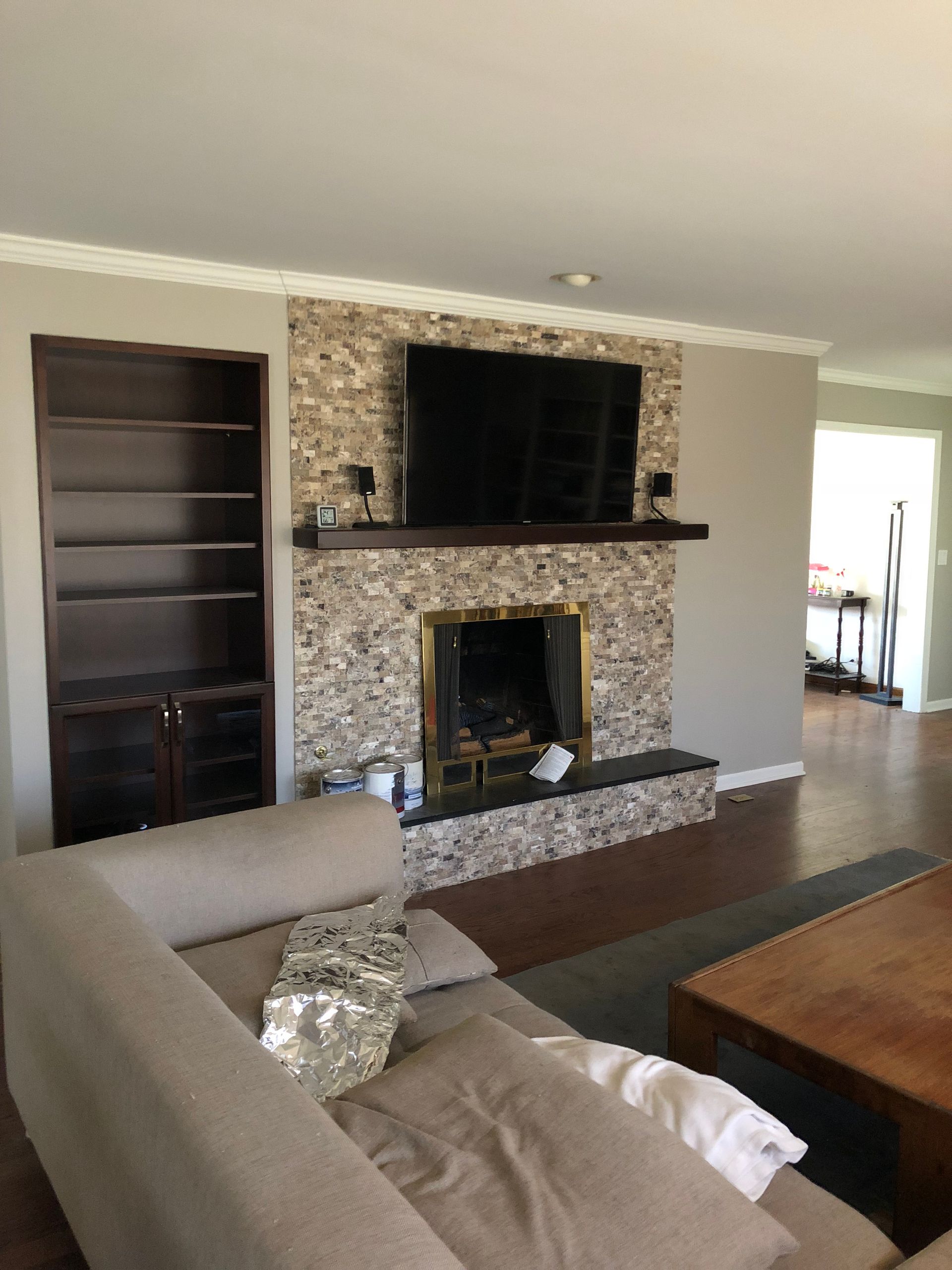A living room with a fireplace and a flat screen tv