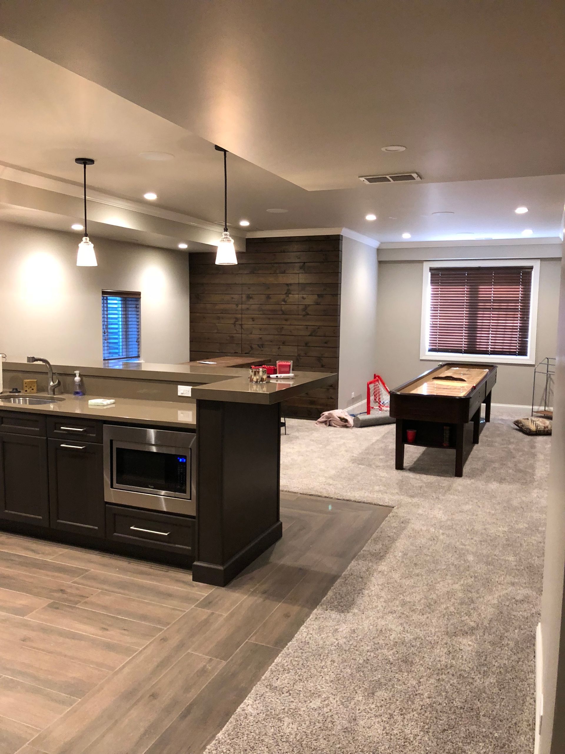 There is a pool table in the middle of the room.