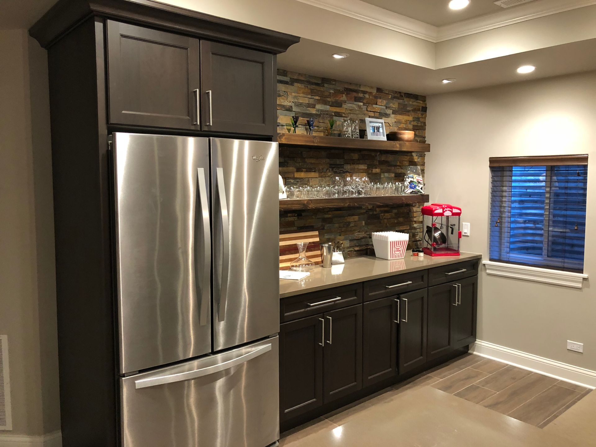 A kitchen with stainless steel appliances and wooden cabinets.