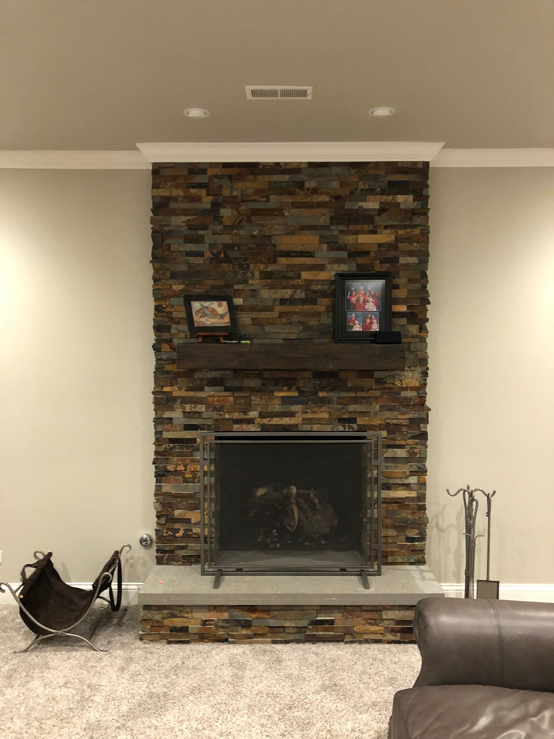 A living room with a fireplace and a couch.