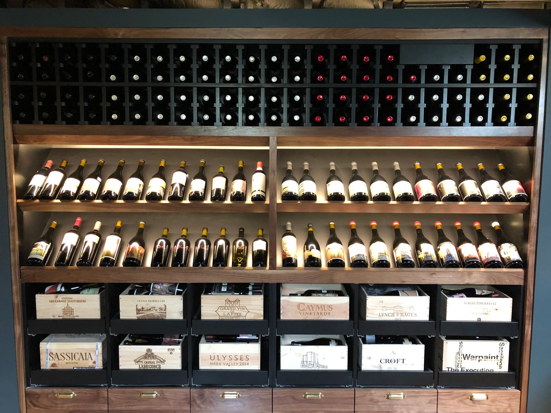 A wine rack filled with lots of bottles of wine.