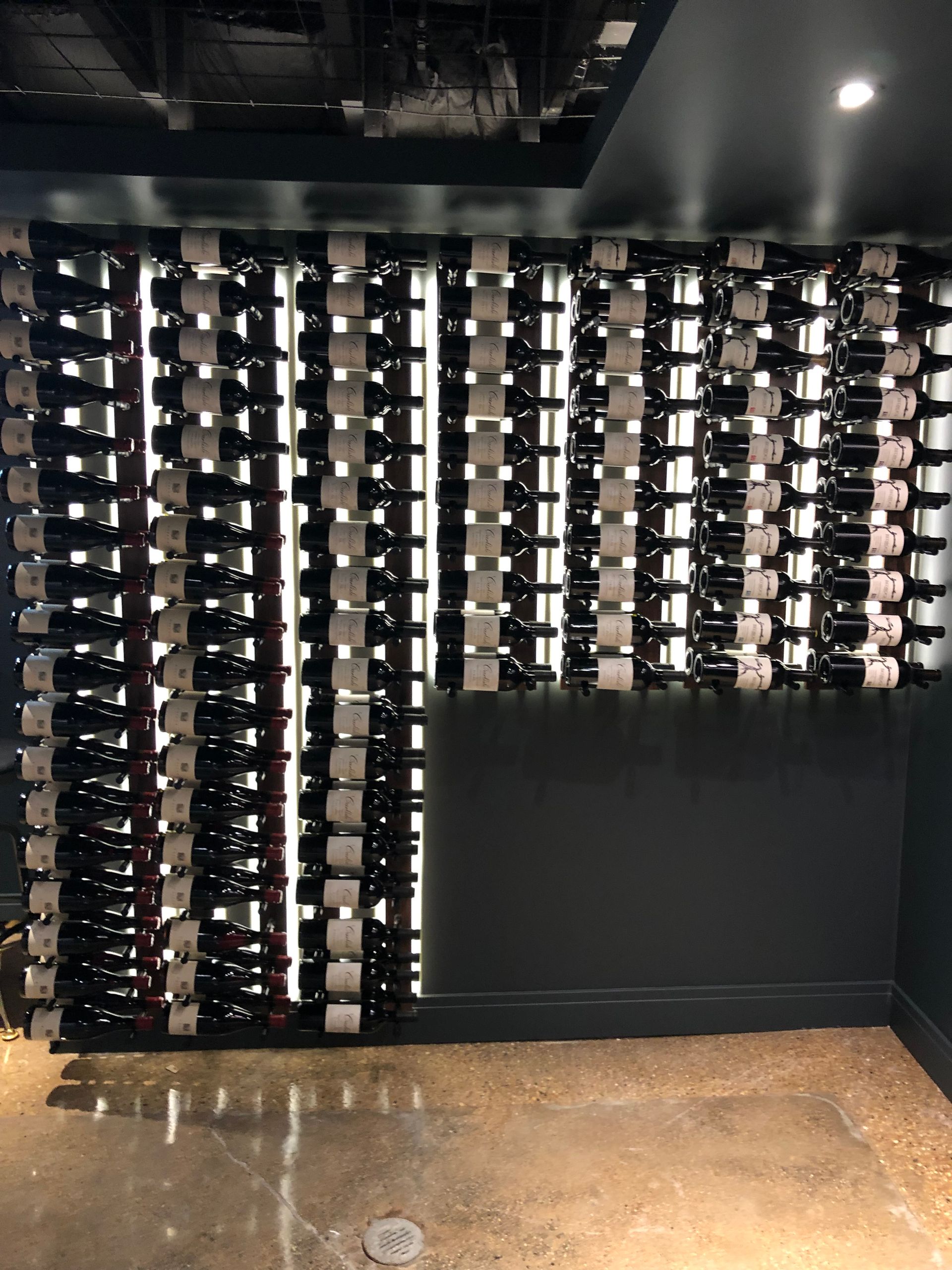 A wall filled with lots of bottles of wine