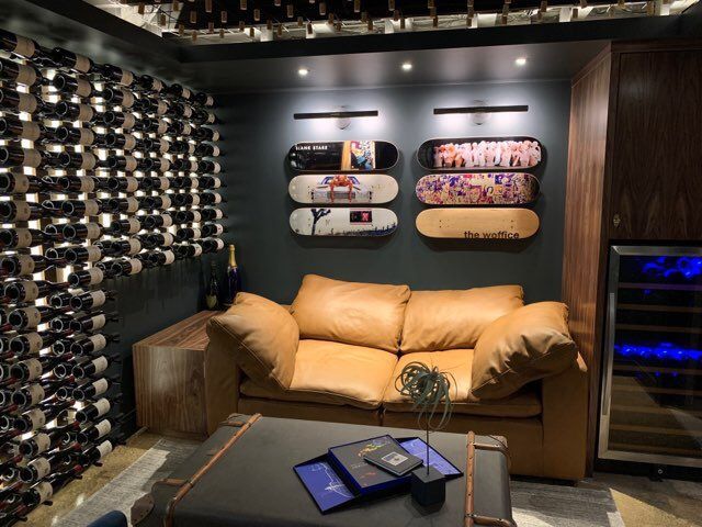 A living room with a couch and skateboards on the wall