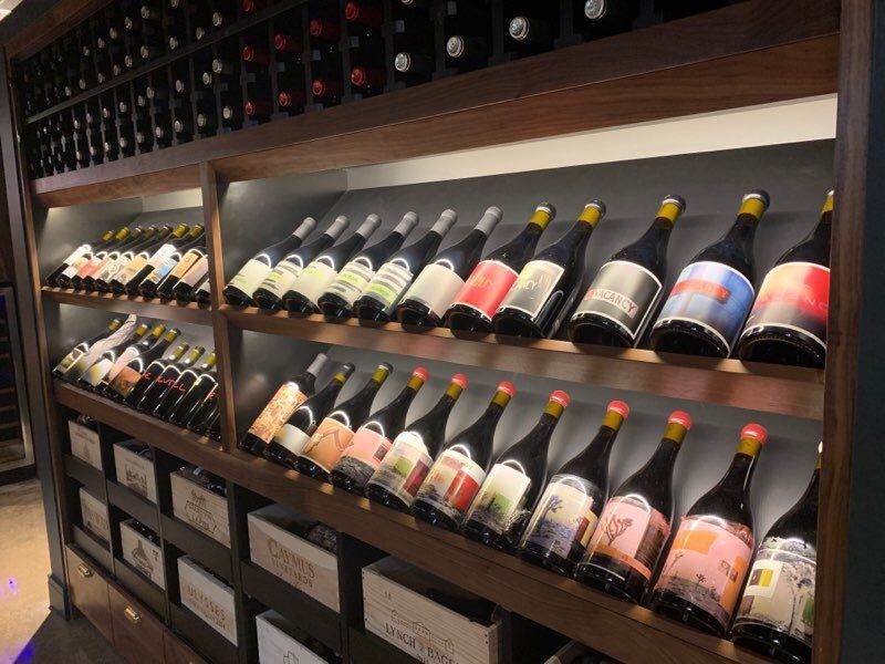 A row of shelves filled with bottles of wine.