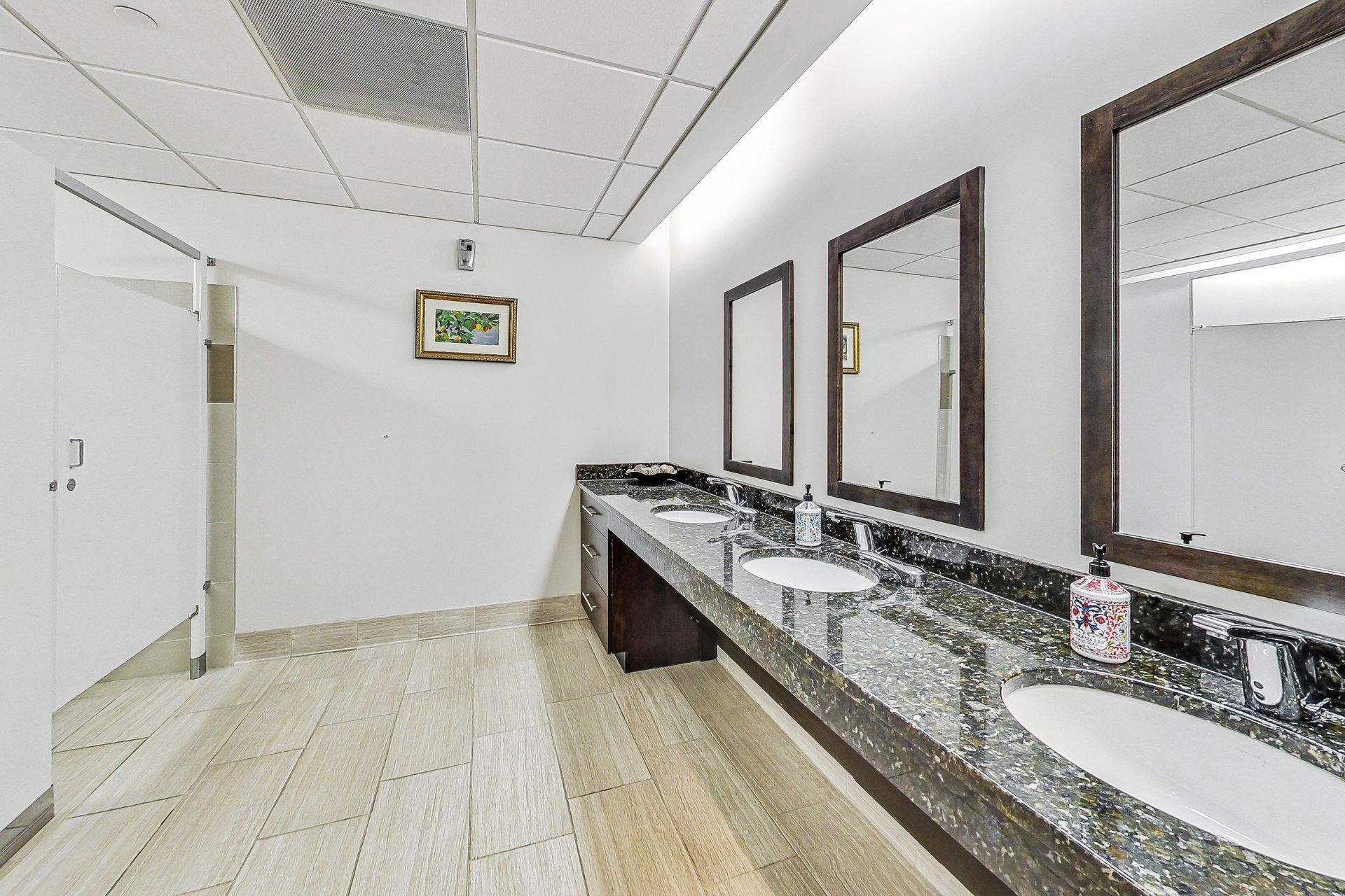 A bathroom with a lot of sinks and mirrors