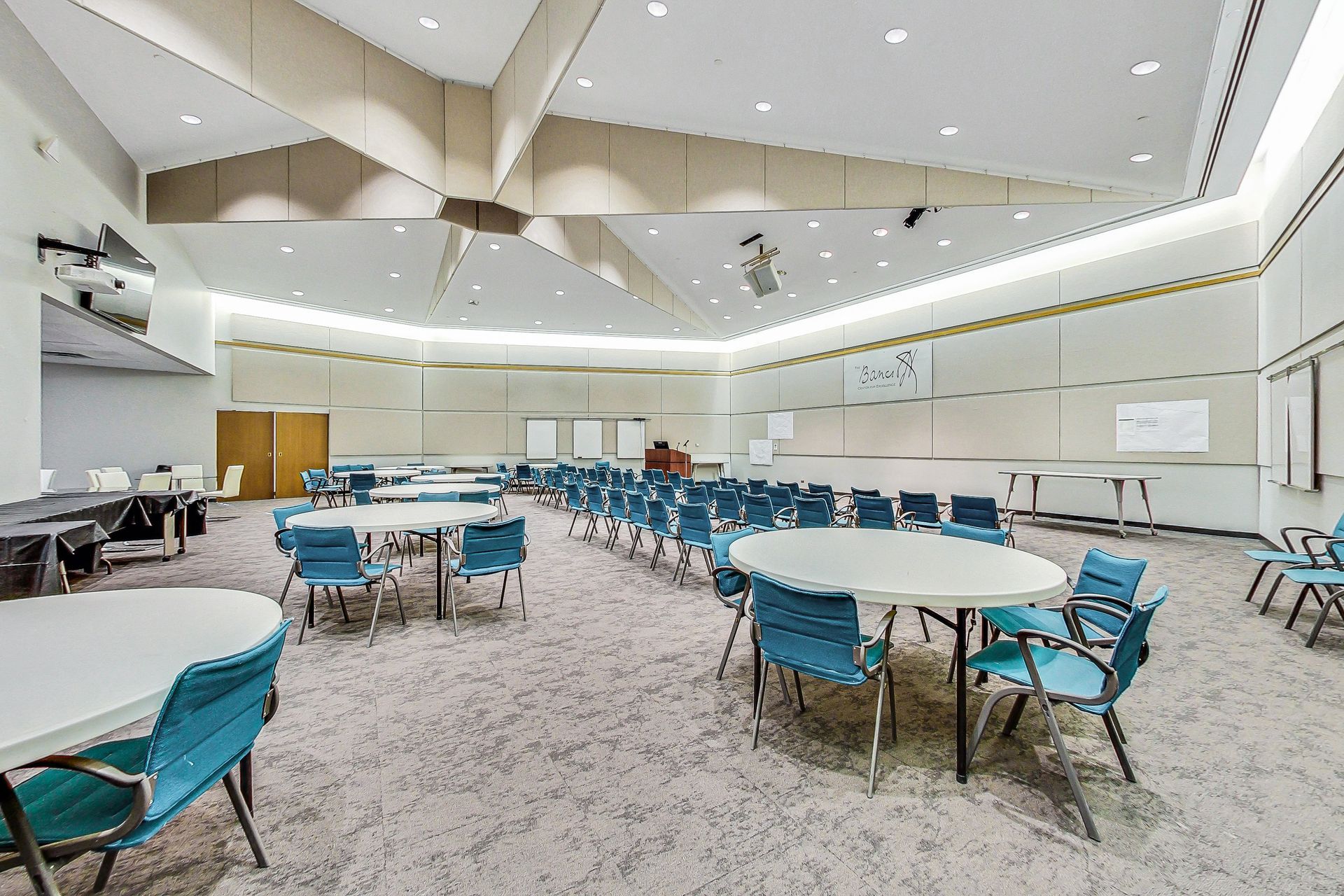 A large room with tables and chairs in it.