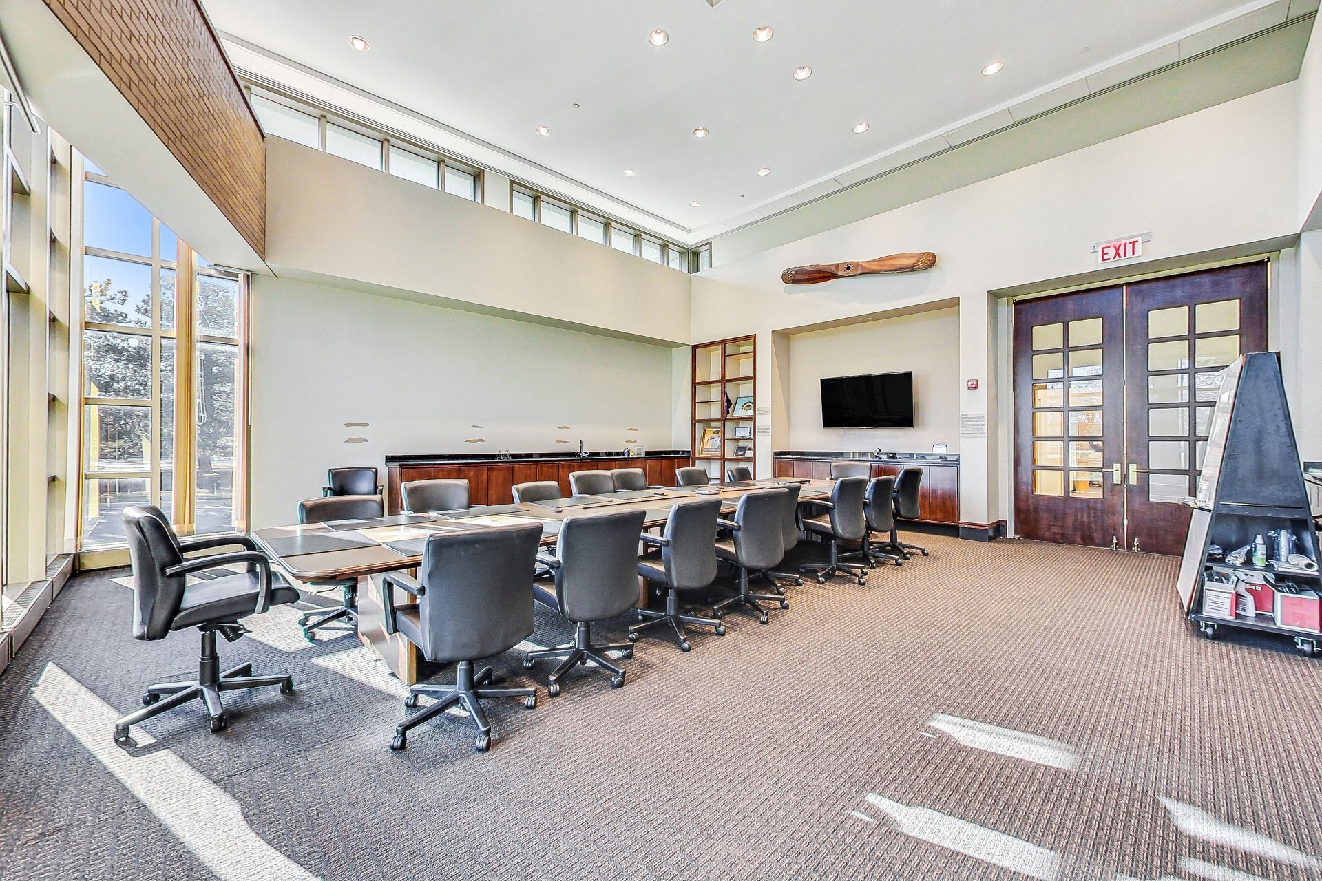 A large conference room with a long table and chairs.