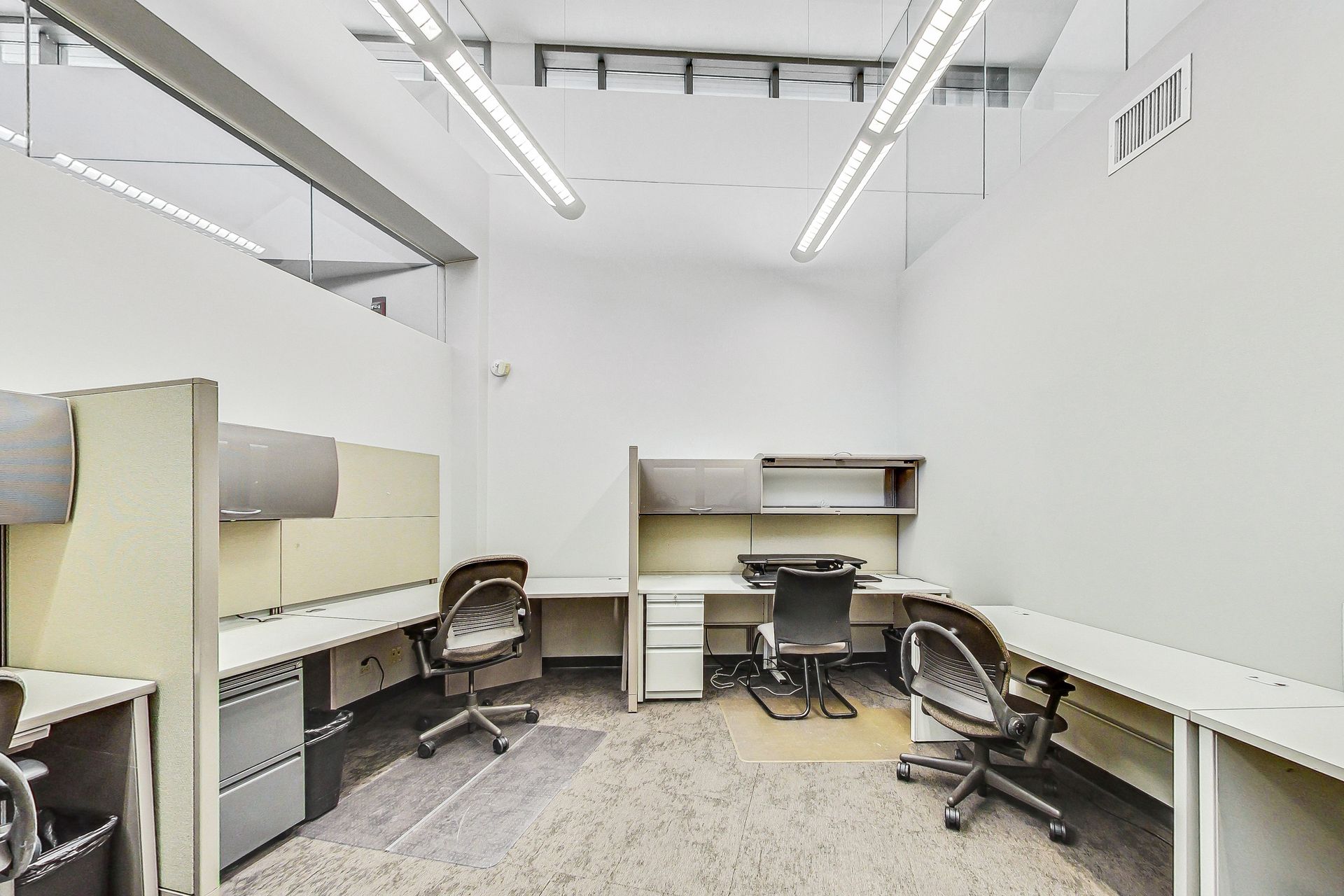 An empty office with cubicles and desks and chairs