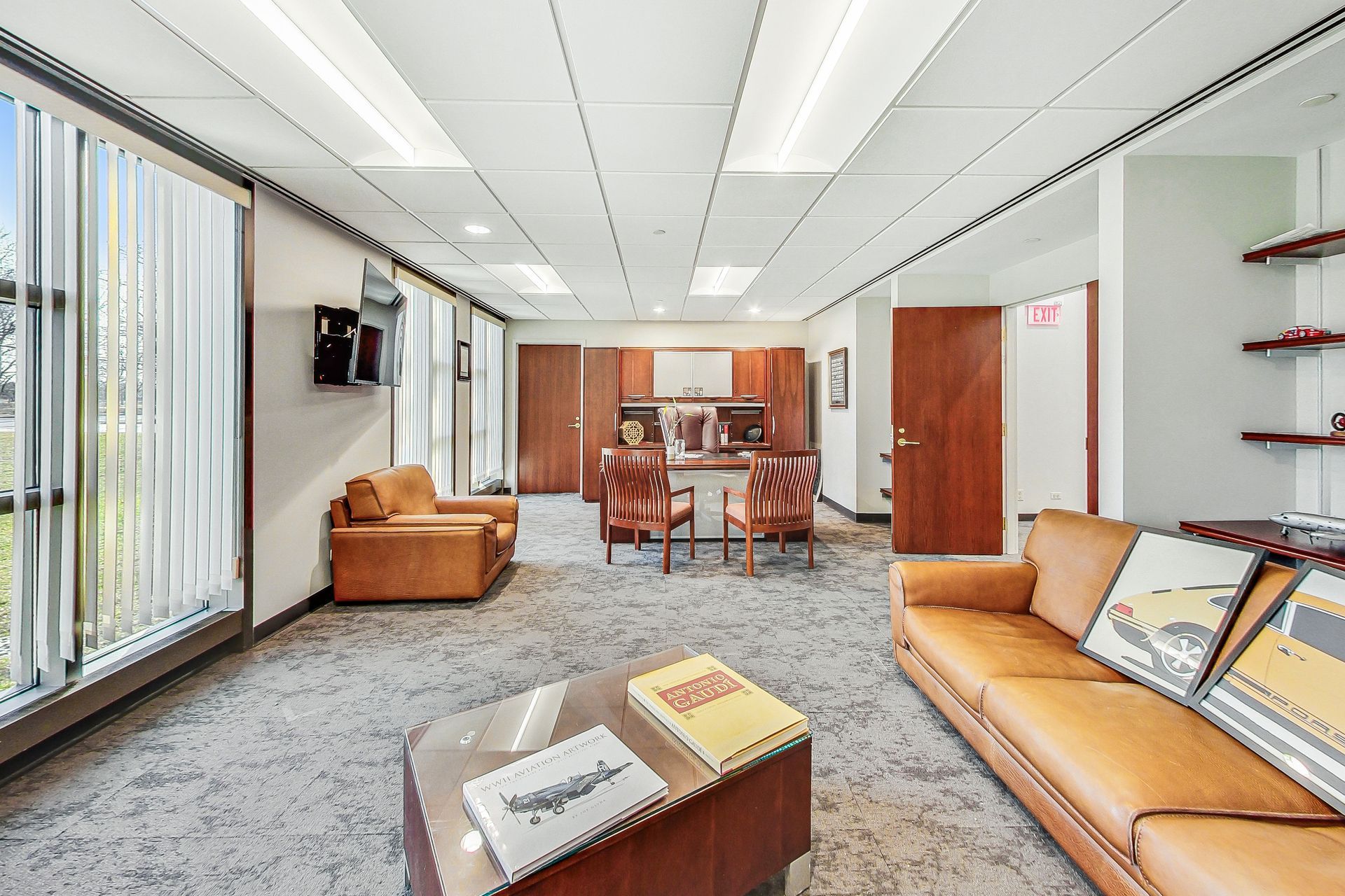 A living room with a couch , chairs , and a table.