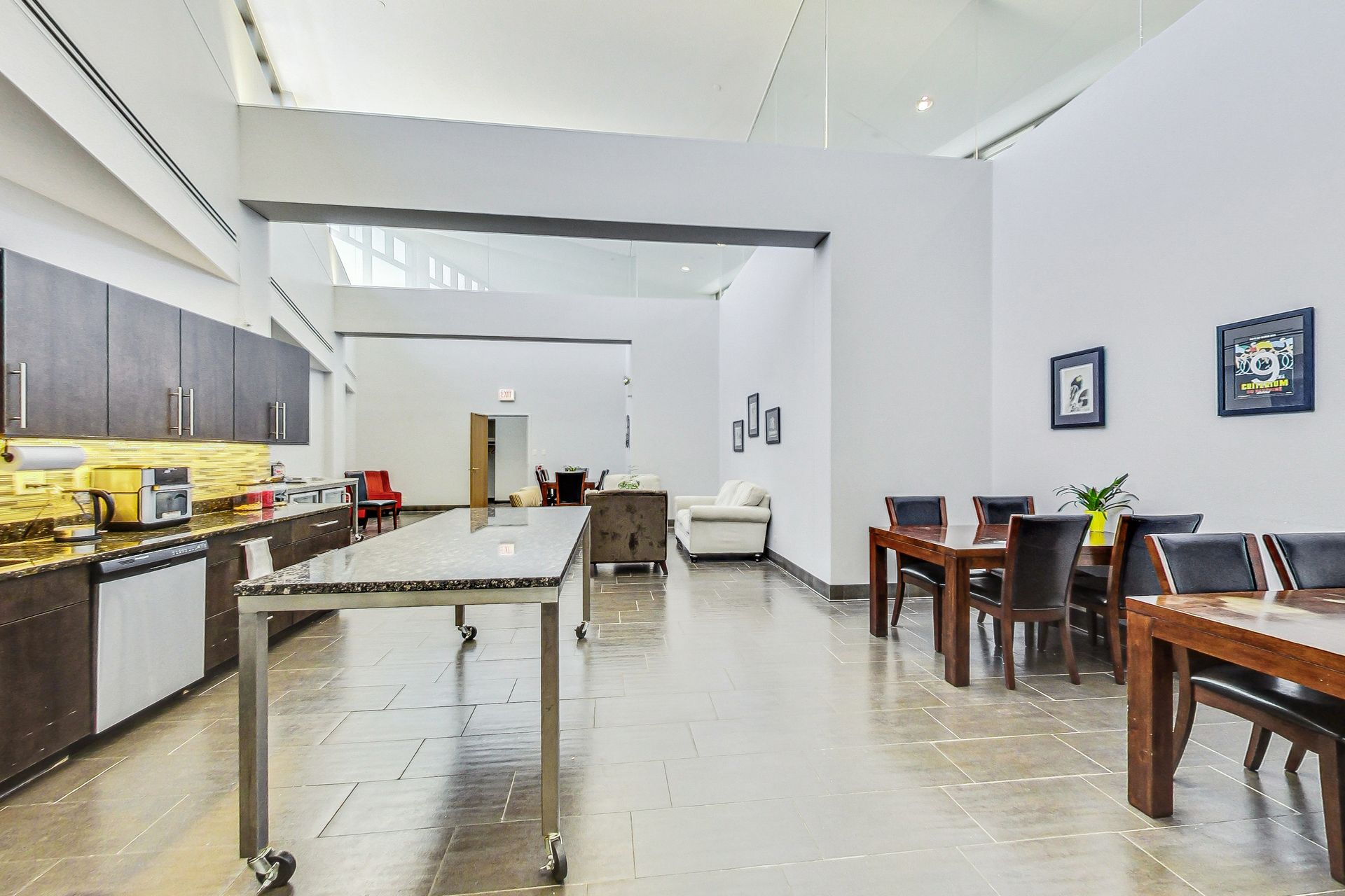 A large room with a table and chairs in it