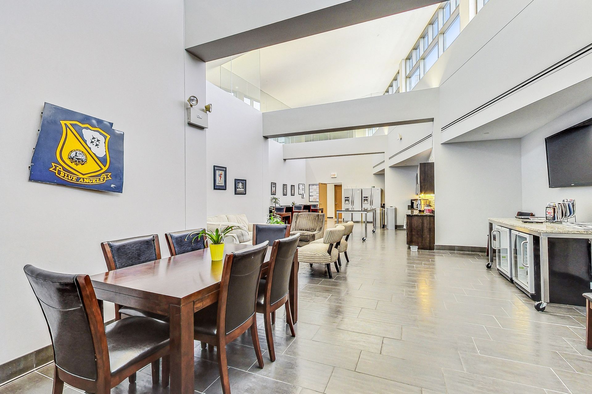 A large room with a table and chairs and a flag on the wall.