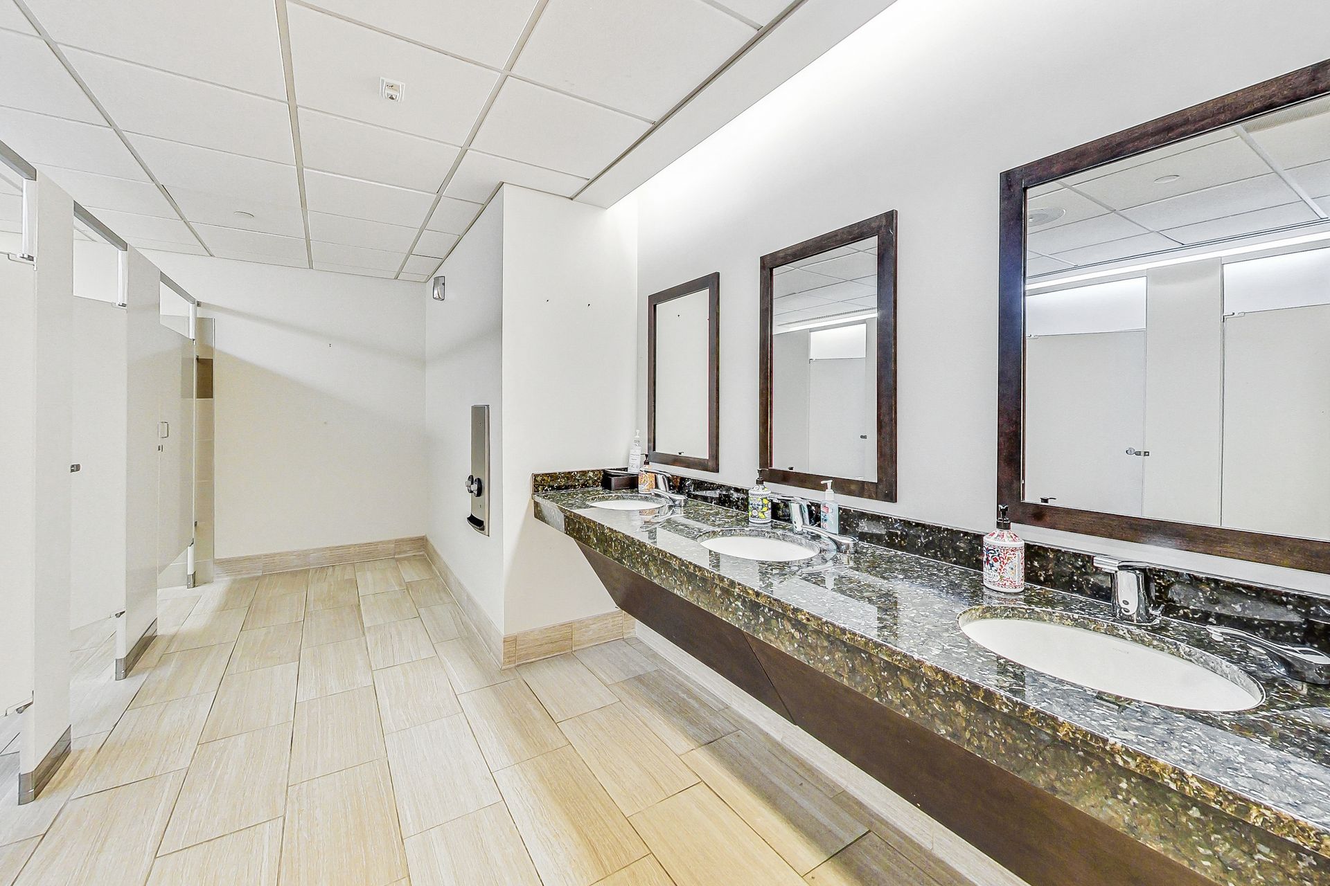 A bathroom with two sinks and two mirrors.