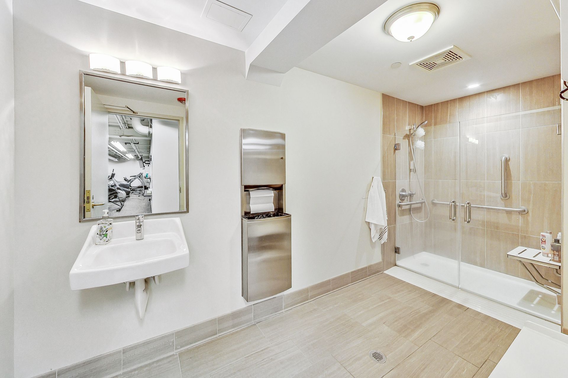 A bathroom with a sink and a walk in shower.
