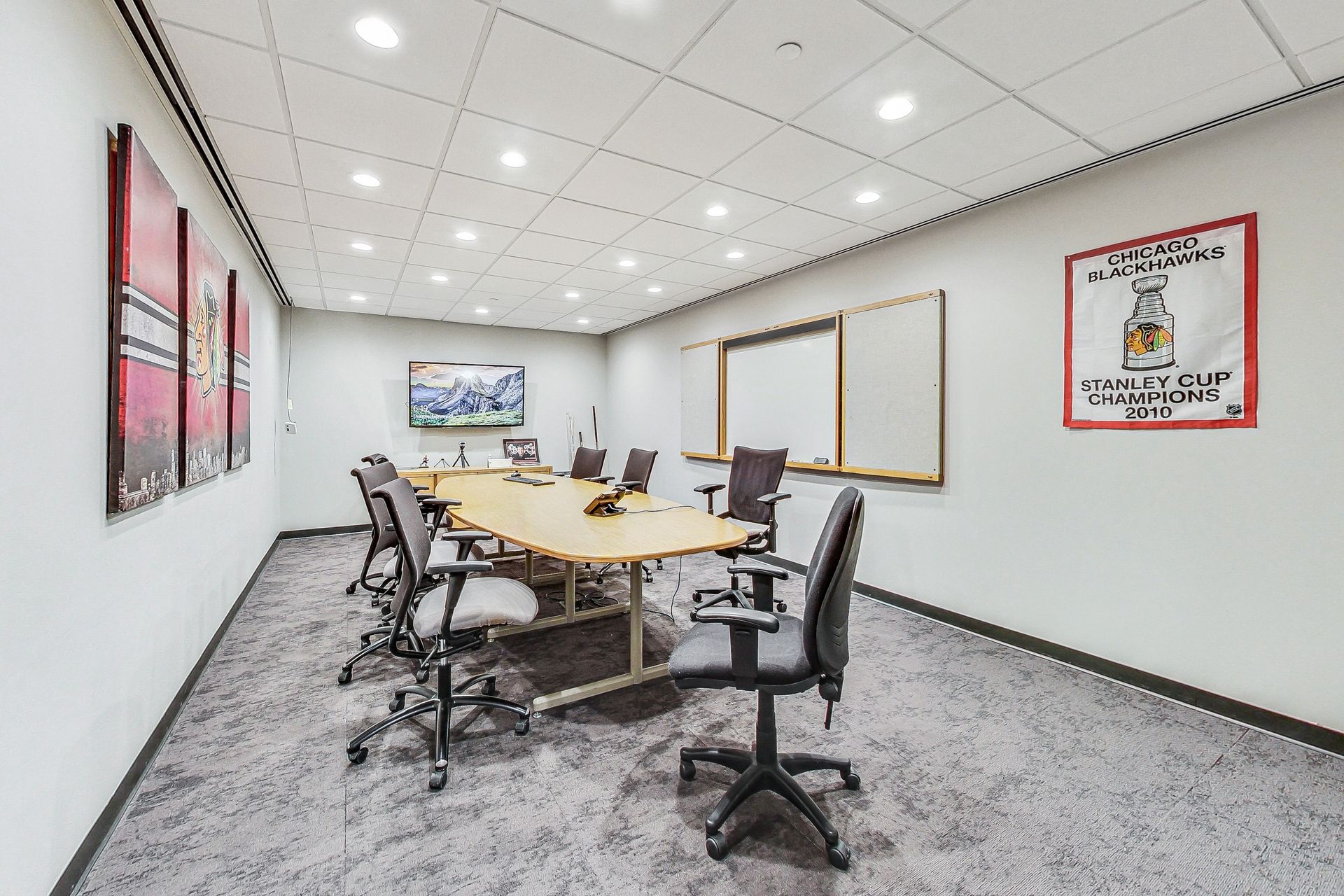 A large conference room with a long table and chairs.