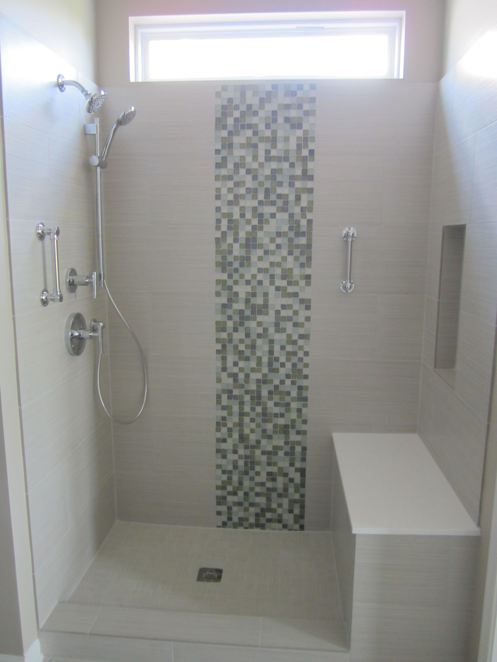 A bathroom with a walk in shower and a window