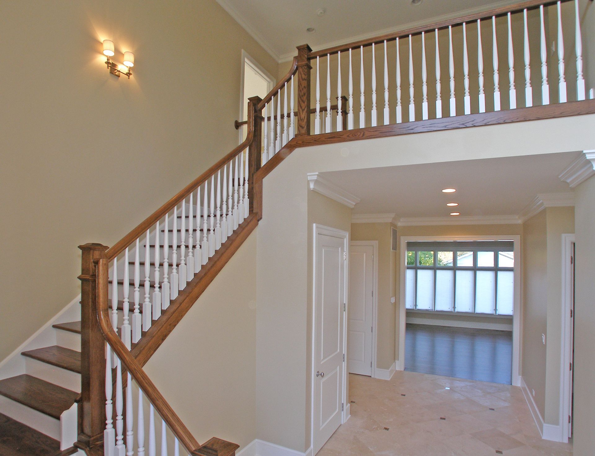 A wooden staircase with white railings in a hallway