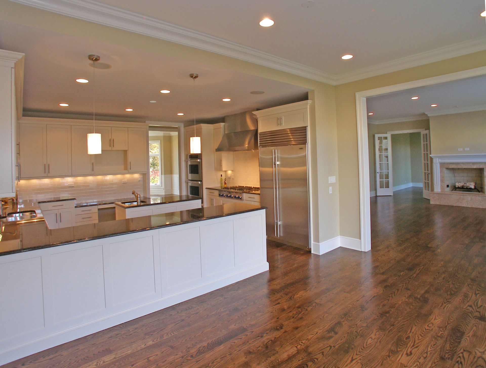 A kitchen with stainless steel appliances and white cabinets